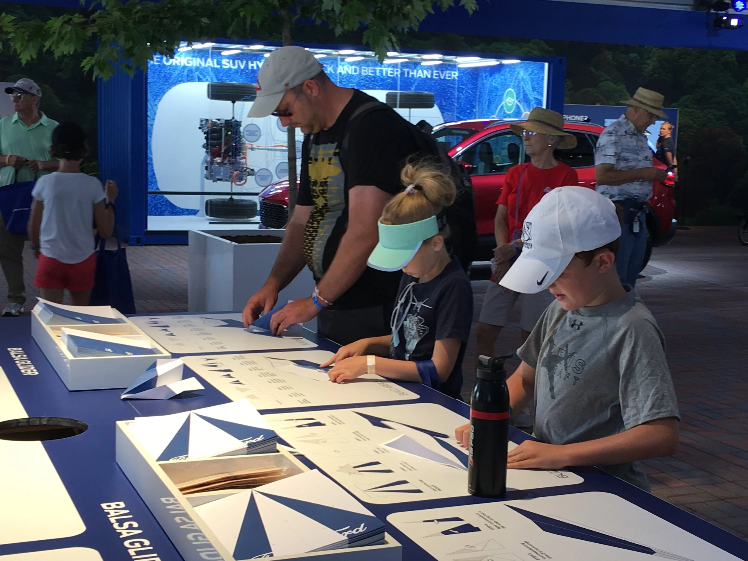  The family-friendly nature of this event created an opportunity to include many interactive games and activities. At this table, visitors could make their own paper airplanes using custom designs created for the event. 
