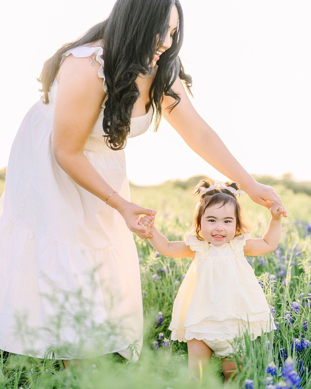 Truly the most beautiful Texas spring session 💙 
Mom in white, barefoot in the bluebonnets. Dad in classic denim. Baby girl toddling between them, bathed in golden light. It was everything timeless and tender &mdash; the kind of session that makes y