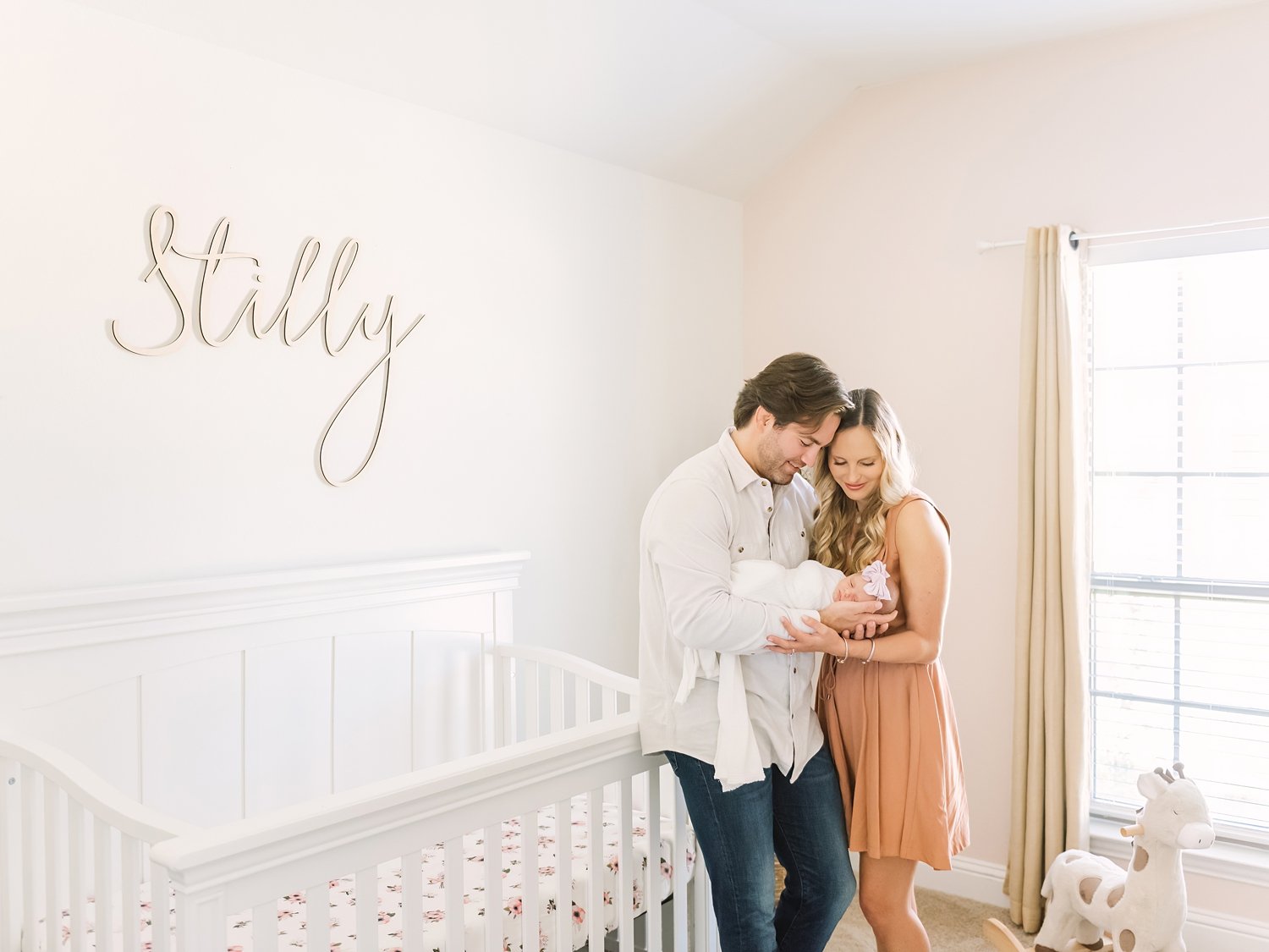 parents newborn baby at home in nursery natural and relaxed