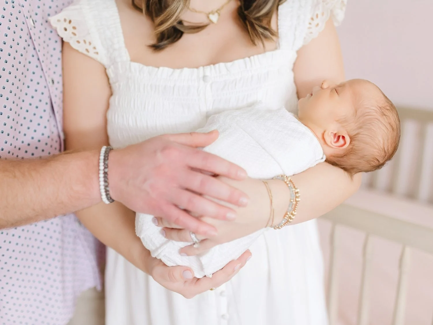 newborn session with baby in parents arms