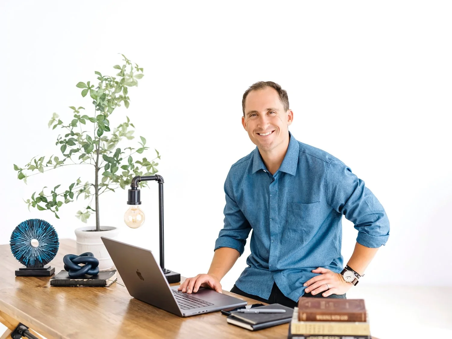 small business owner personal branding and head shots sitting at a desk with laptop and books