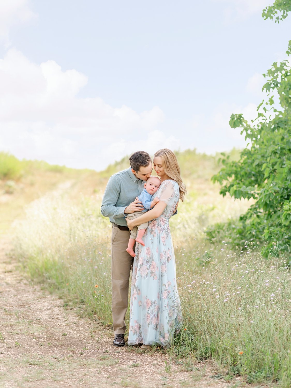 young family photo taken in a Plano, texas field