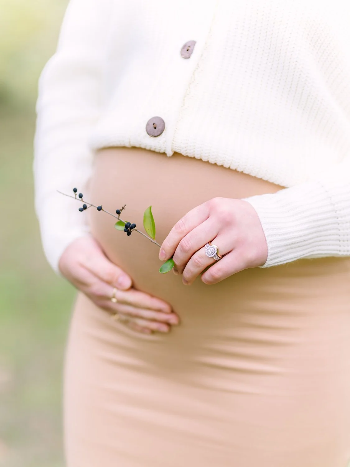 expectant mom holding a flower maternity