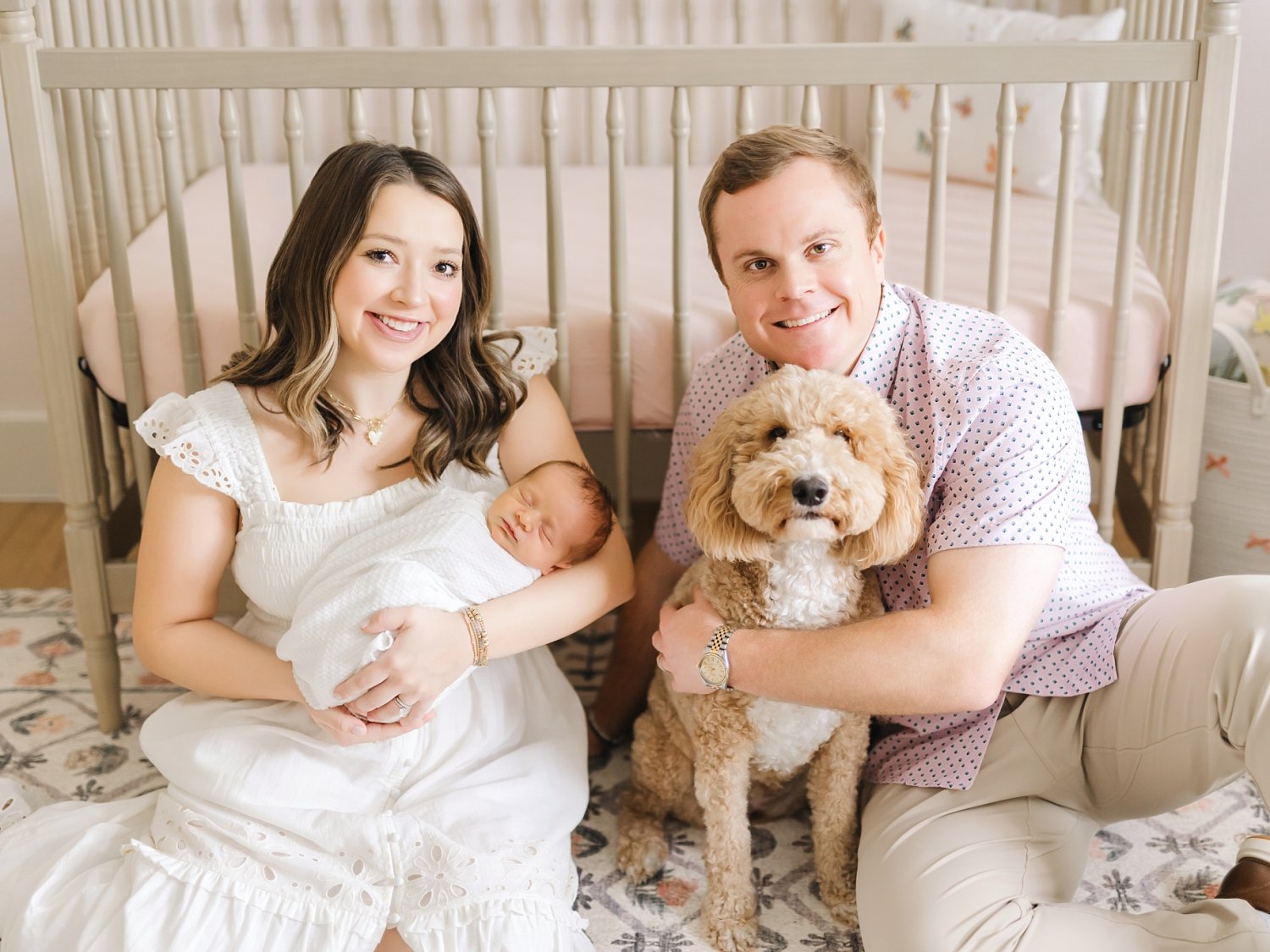 photo of a family at home with newborn and family pet