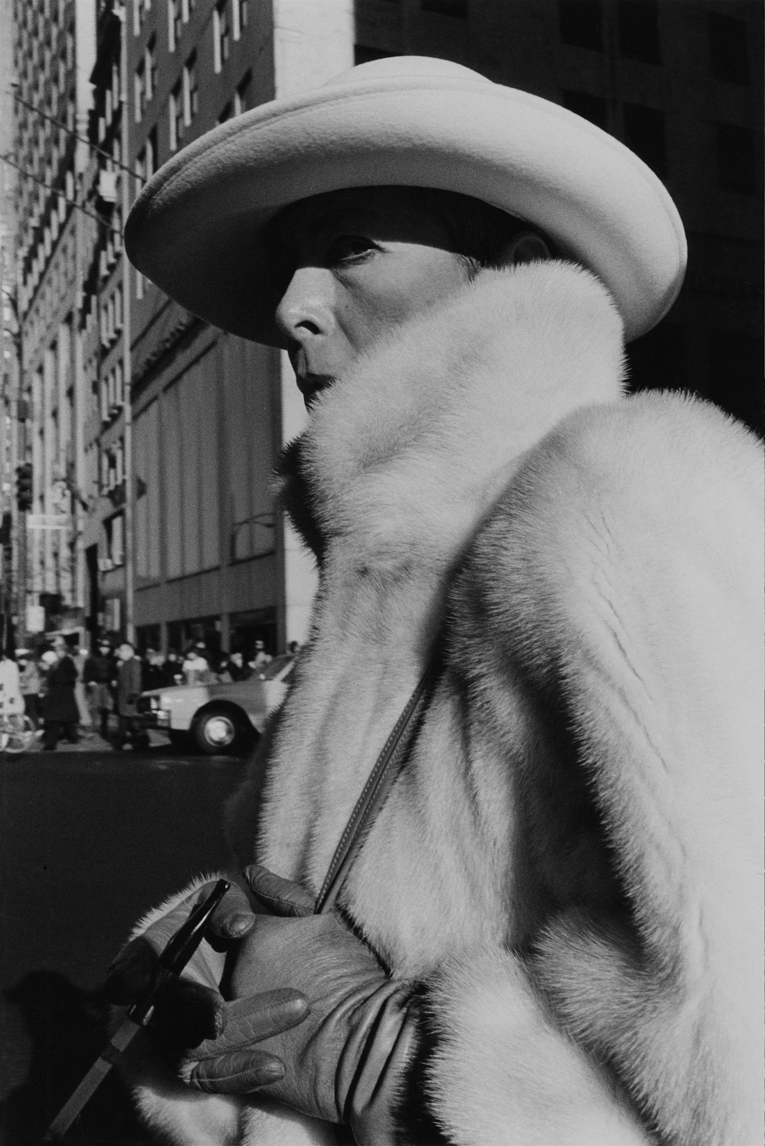 glamorous woman with cig in white fur, 5th ave., c. 1984