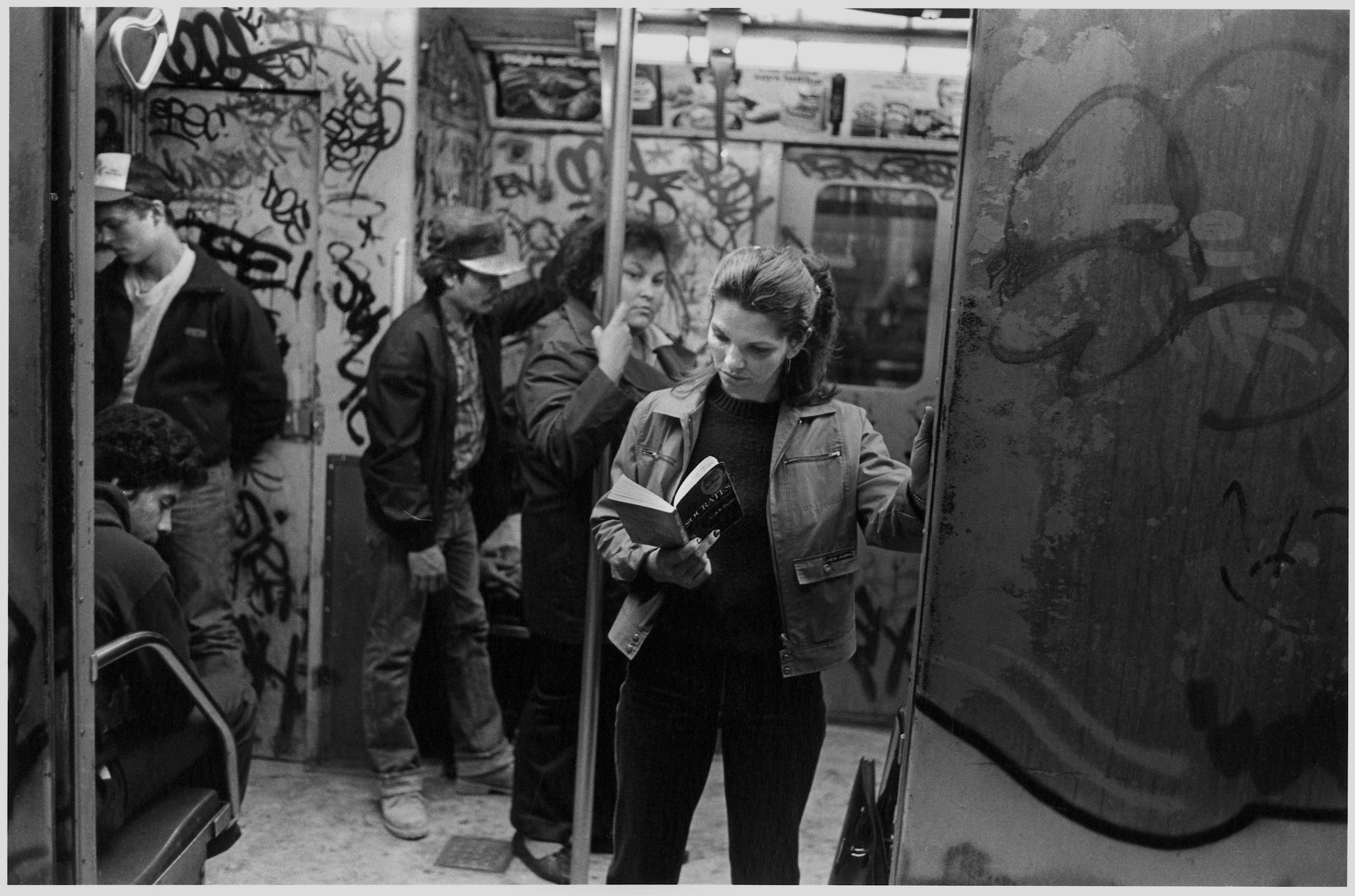 reads socrates on the irt, nyc, c. 1985