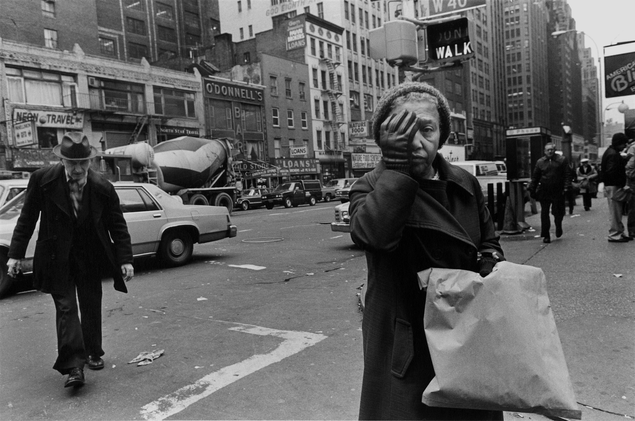 woman with hand over one eye, 8th ave., nyc, c. 1986