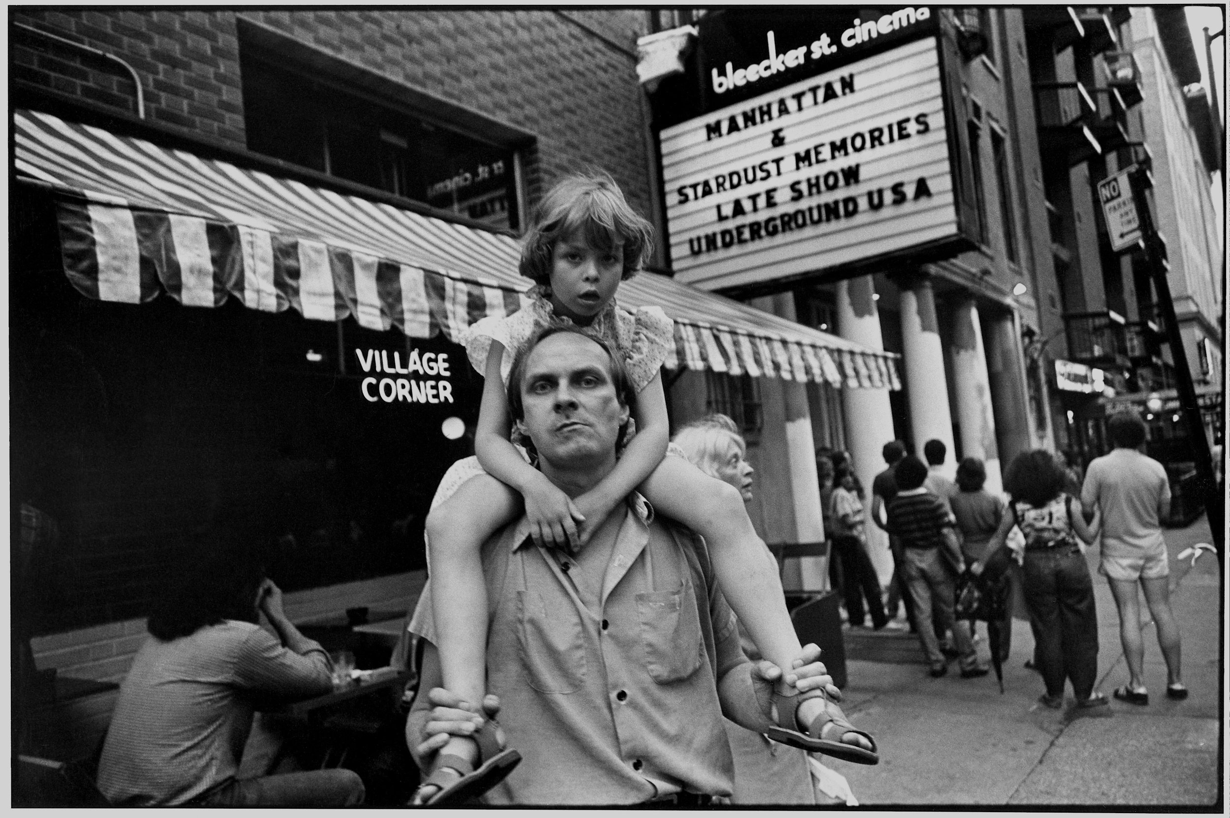 young girl on dad's shoulders, bleecker st cinema, nyc, c. 1985