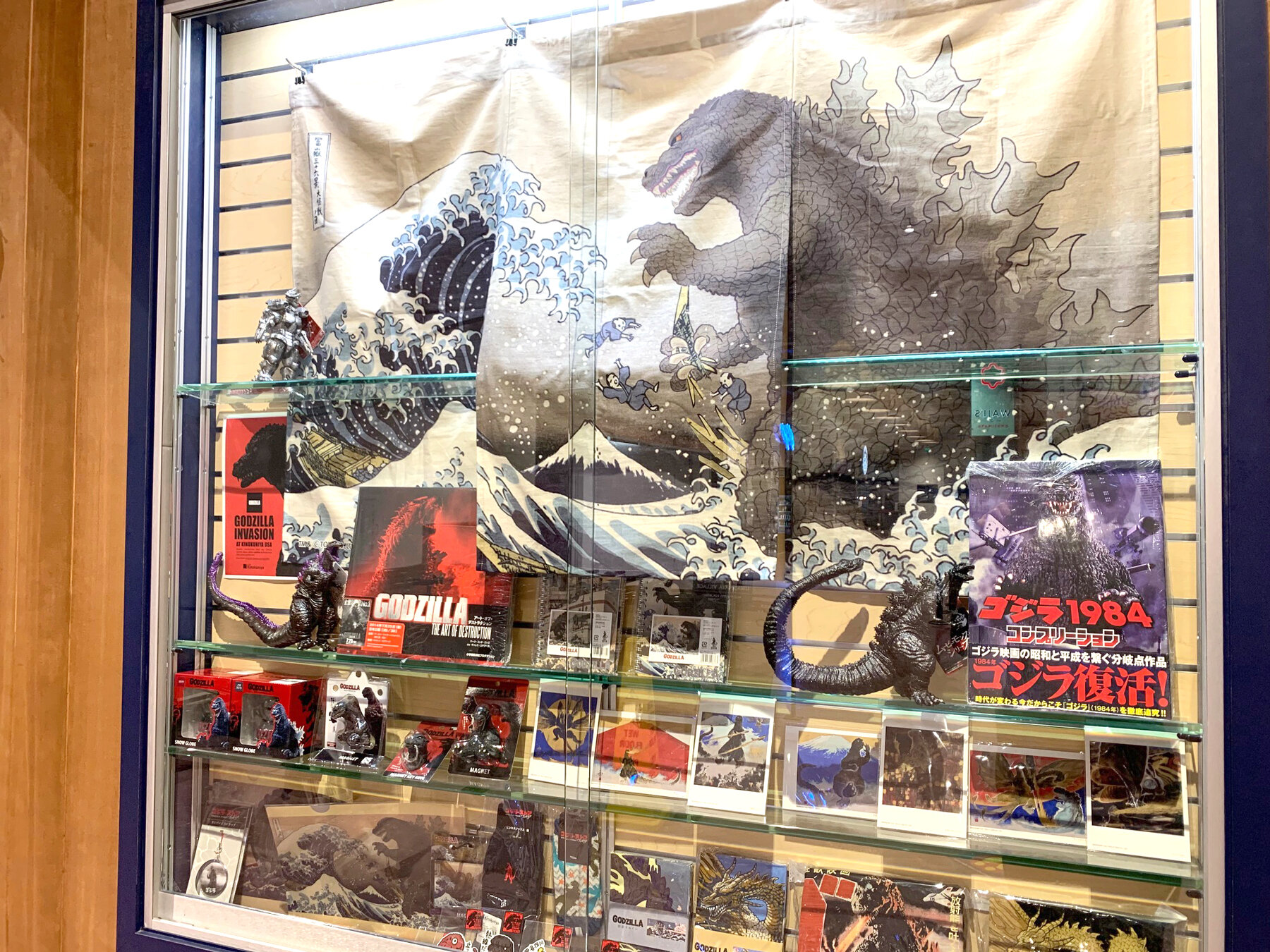  Godzilla merch in a store window. 