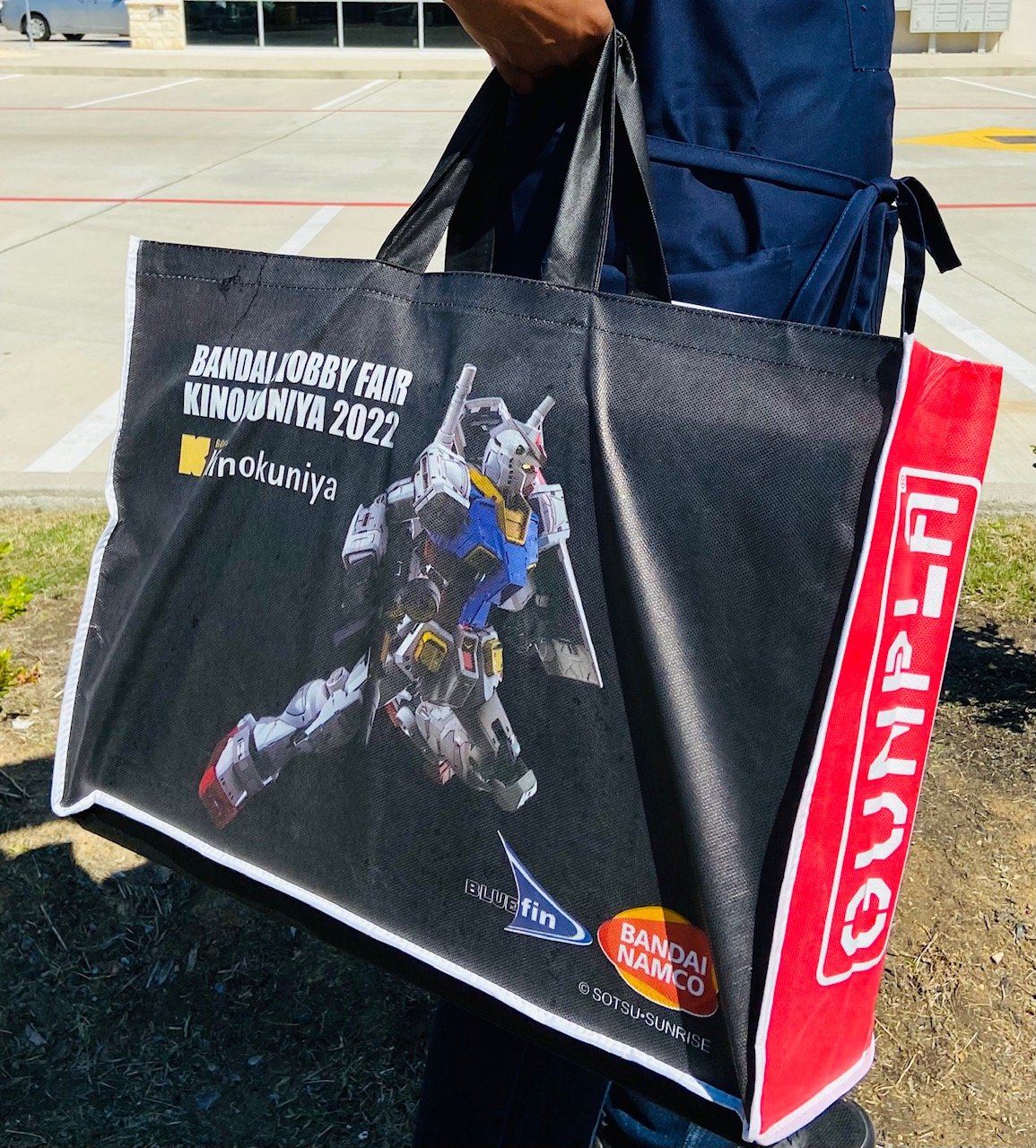  A person holding the Kinokuniya Exclusive bag 