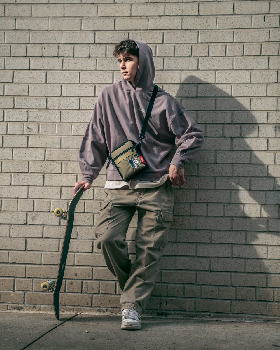  man with a skateboard wearing a Manhattan Portage x Attack on Titan bag 