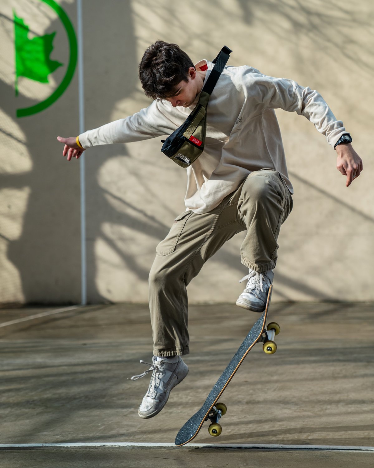 man with a skateboard wearing a Manhattan Portage x Attack on Titan bag 