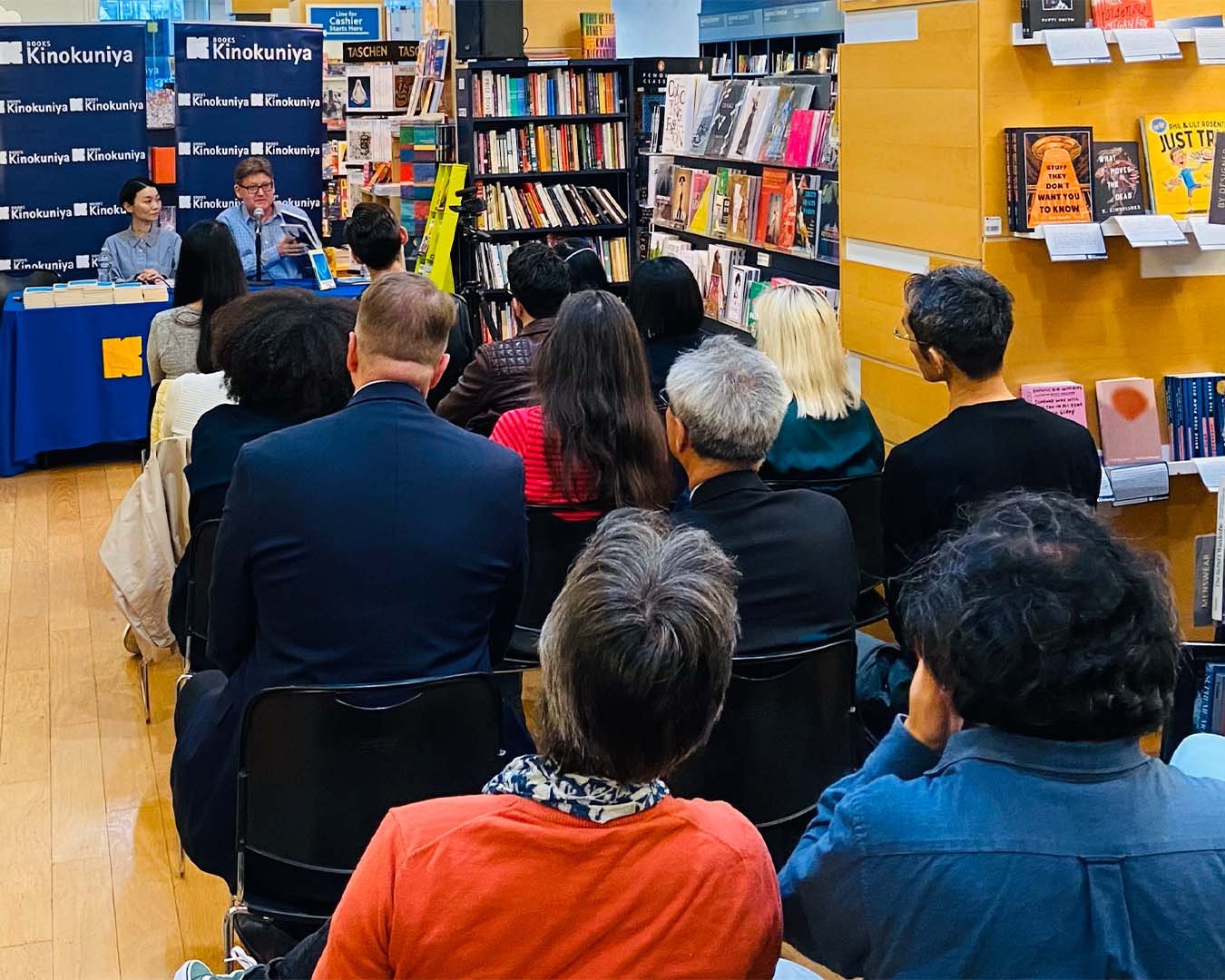 Kaori Fujino and Kendall Heitzman reading in front of crowd