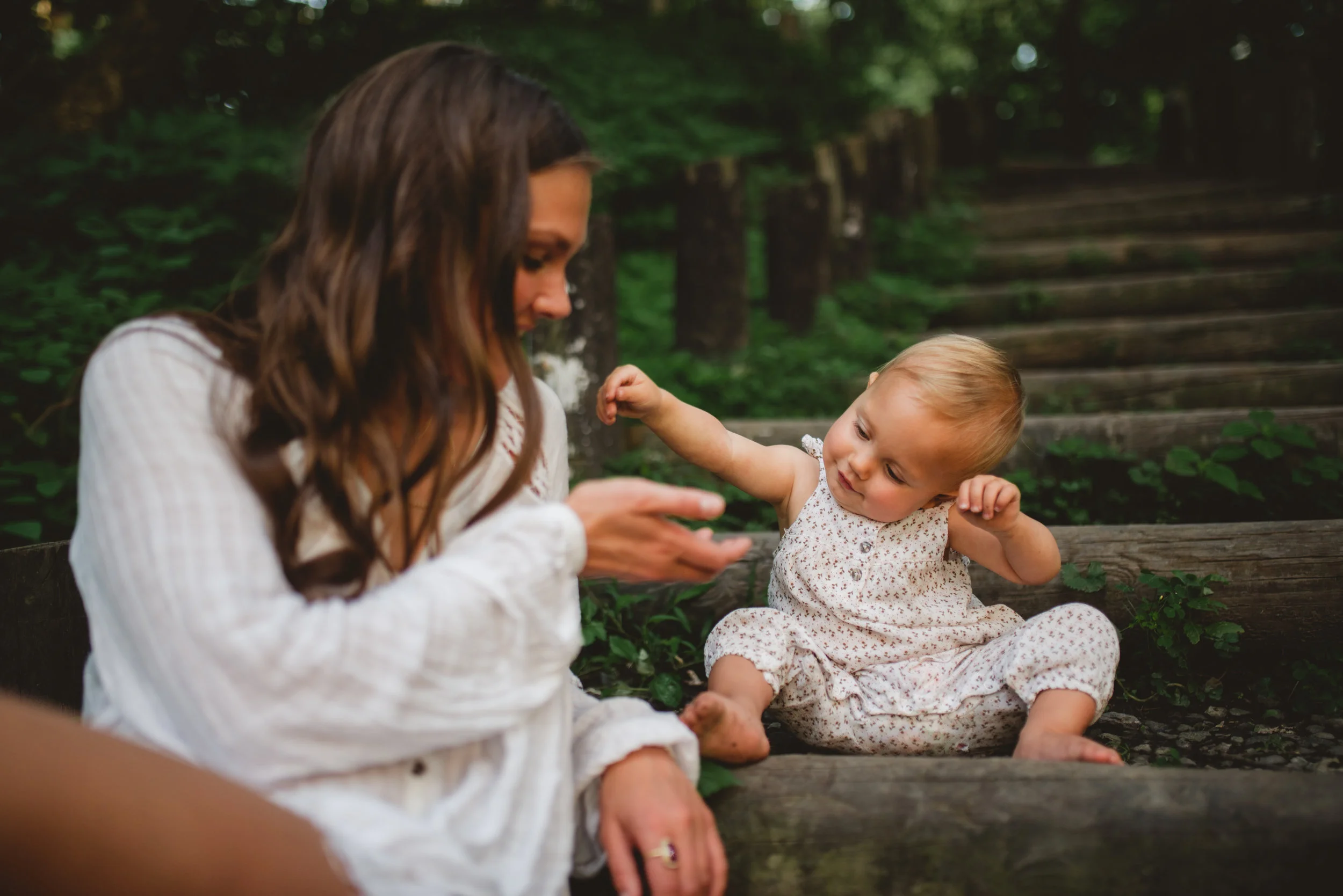 one year old playing with rocks on staircase