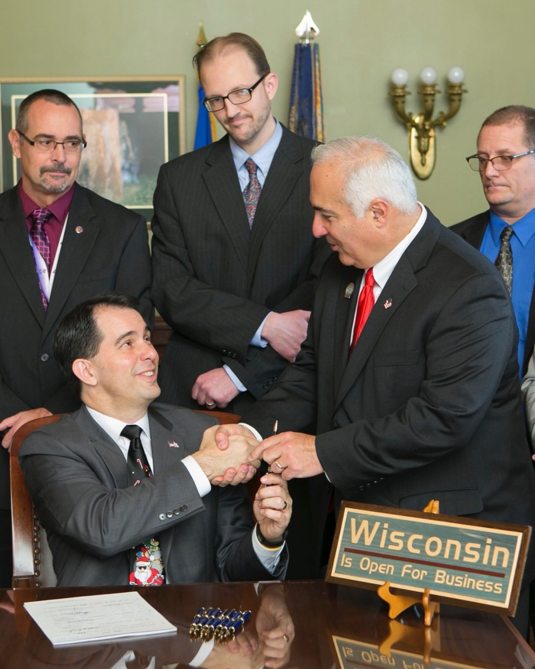 John getting his bill signed by the Governor