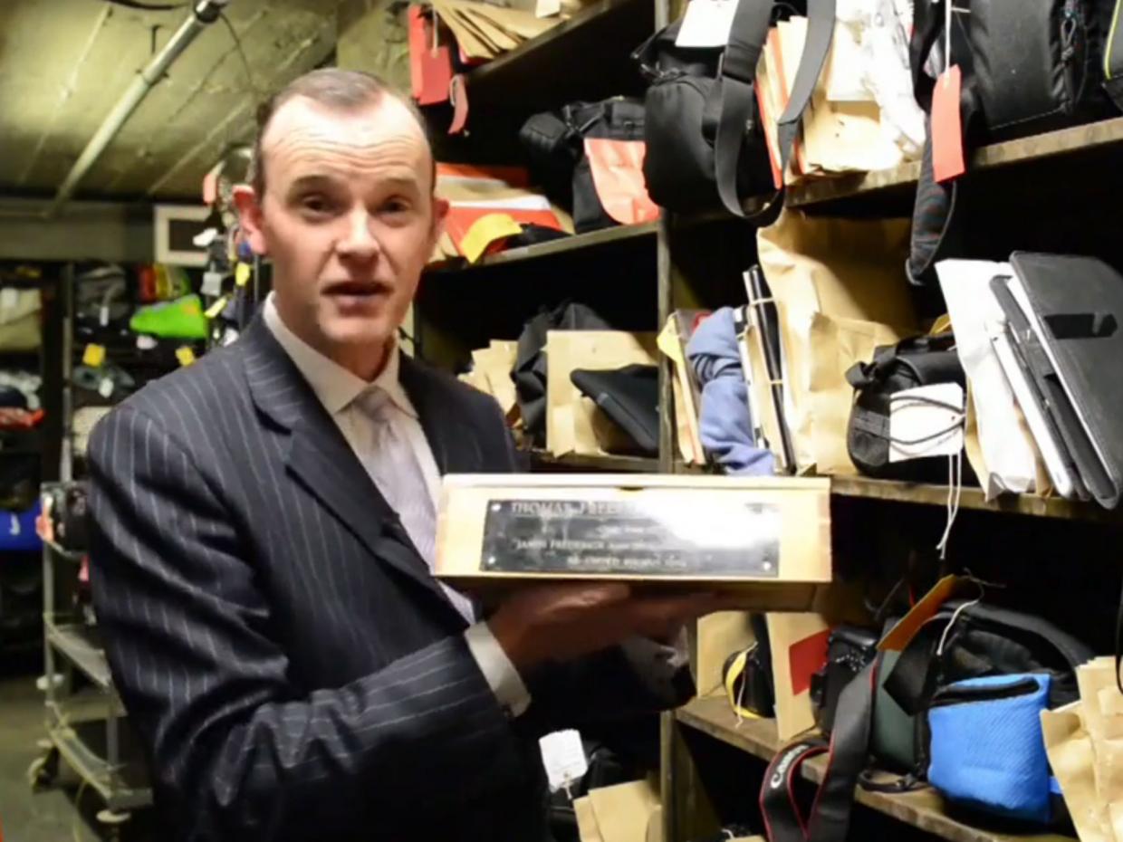 Paul Cowan holds up the box containing the ashes of Thomas Frederick Johnston. Source London Live.