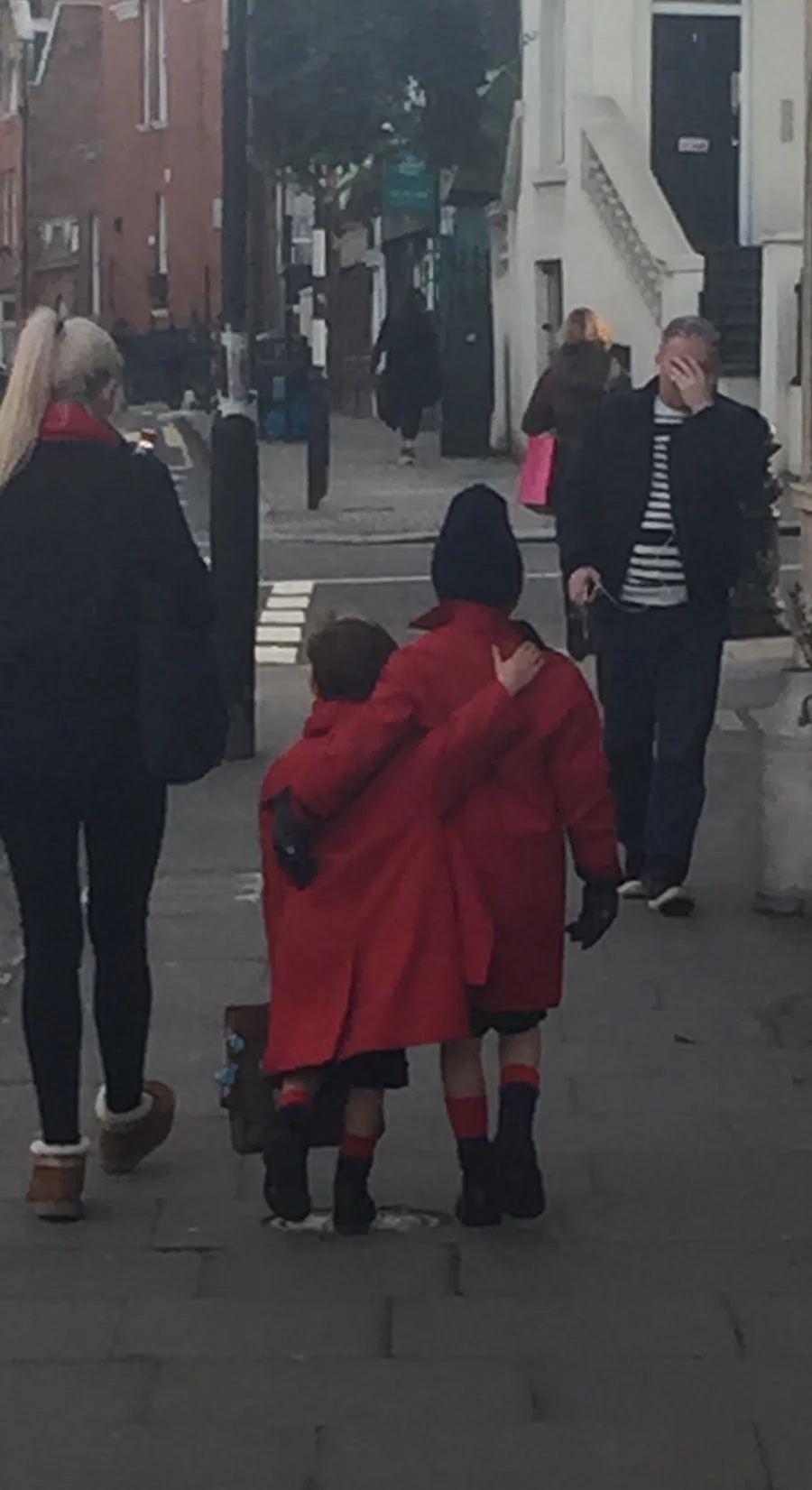 Sisters in Red Coats on Kensington Church Street
