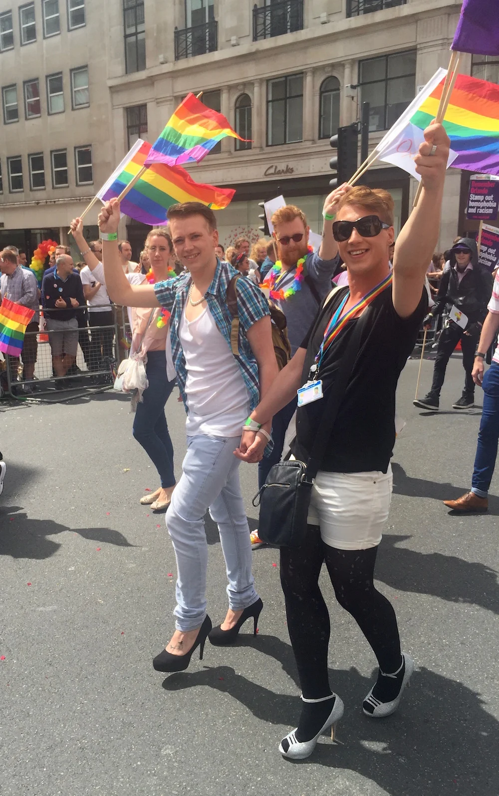 Young men walking in heels at the London Pride Parade.