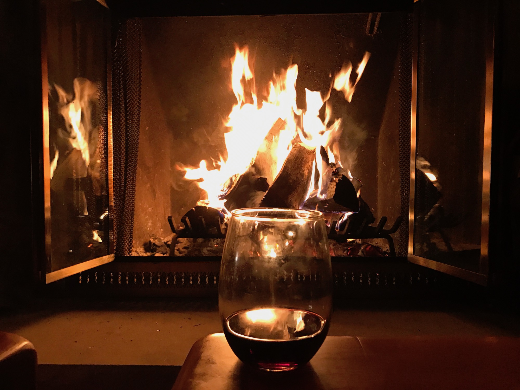 Fire at the ski chalet with glass of wine.jpeg