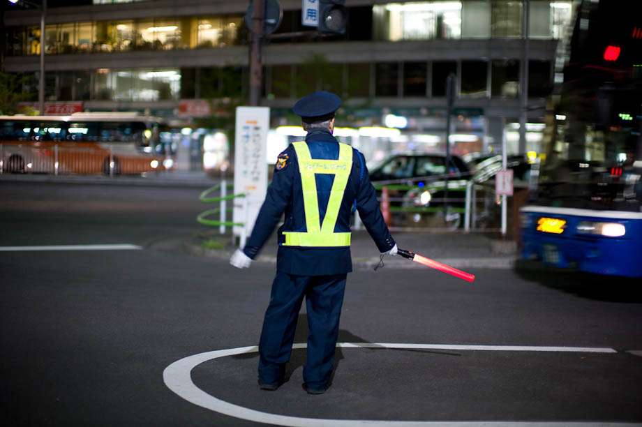 Directing the buses in front of Tokyo Station in Japan.