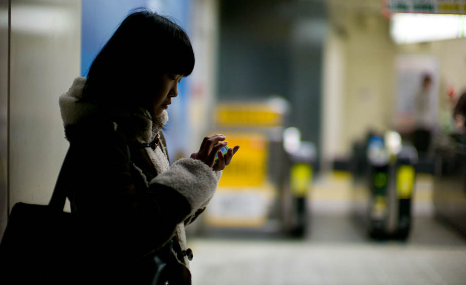 A girl texting at Shibuya Station