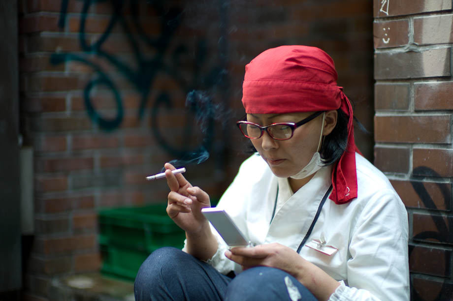 A woman checks news on her phone in Shibuya