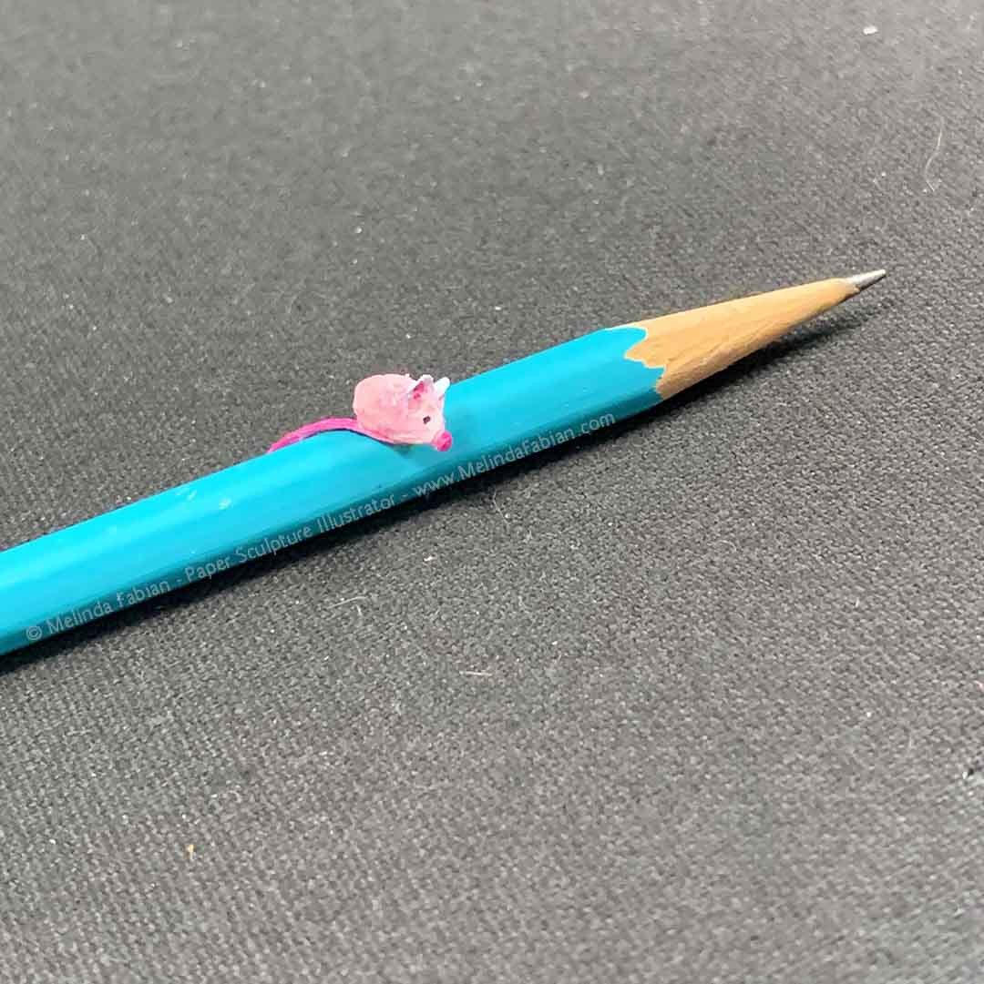 9.)	Paper Mouse setting on top of a pencil 