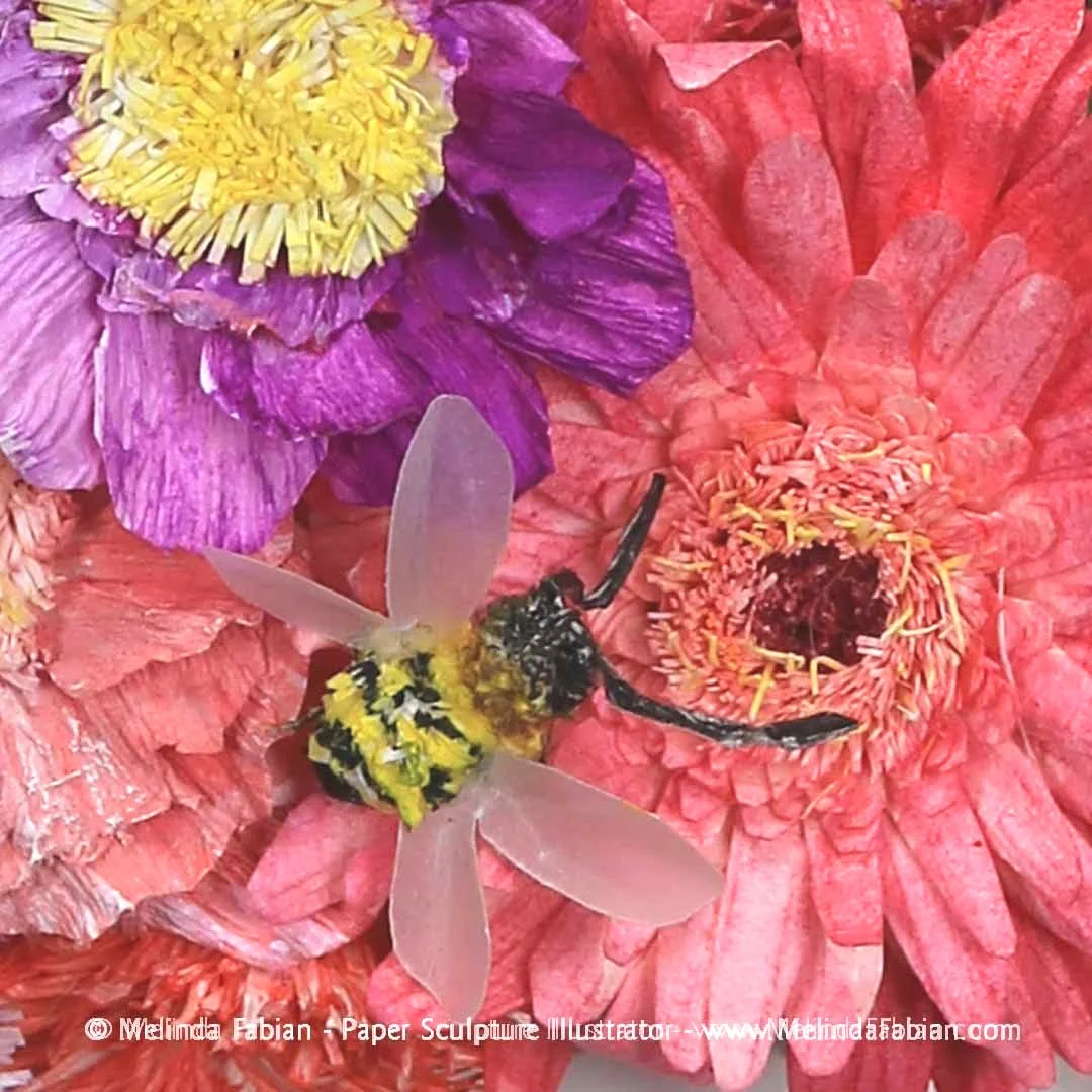 detail view of a paper bee sitting on a daisy