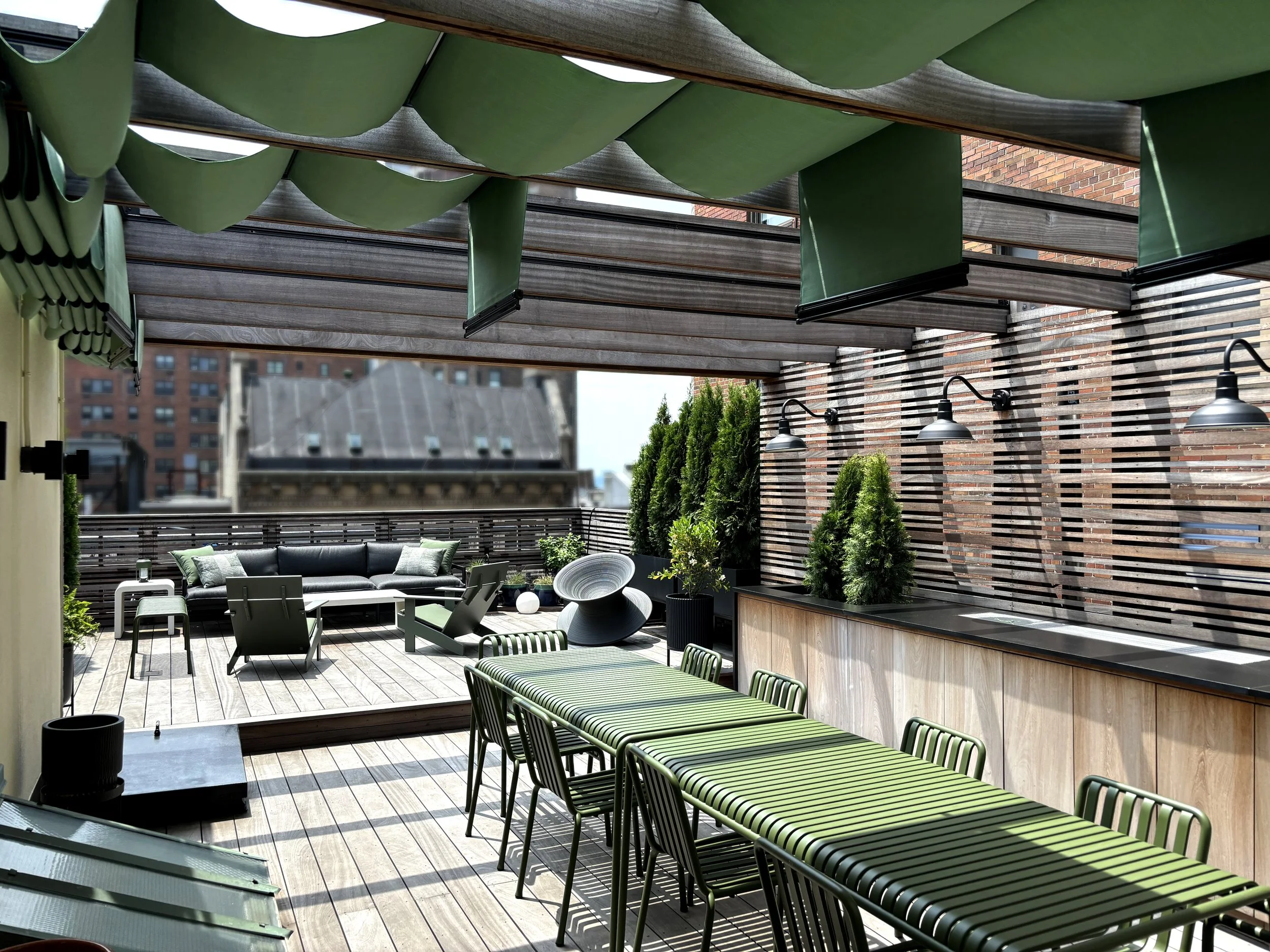 Rooftop garden terrace with custom millwork and retractable shading