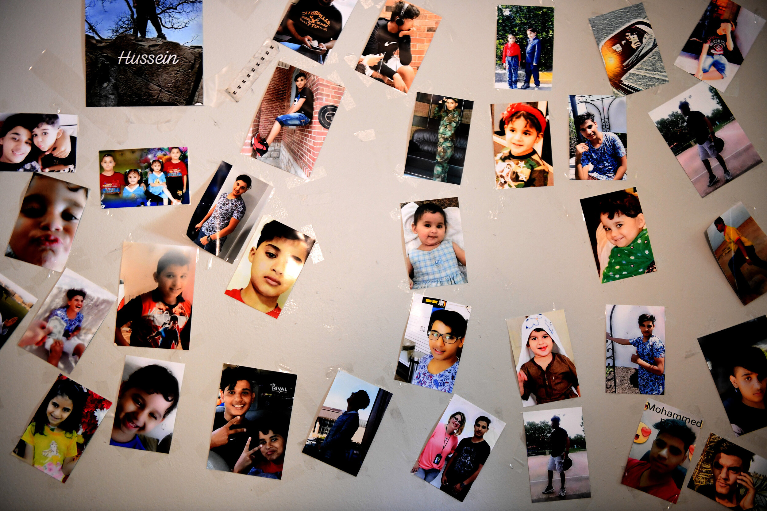  Photos of all nine of the Al Hraishawi children are taped to the wall of Hussein’s room. The entire family was born in Iraq, but some of the older children  spent their whole childhood there. On December 13, 2017, they packed their bags and left the