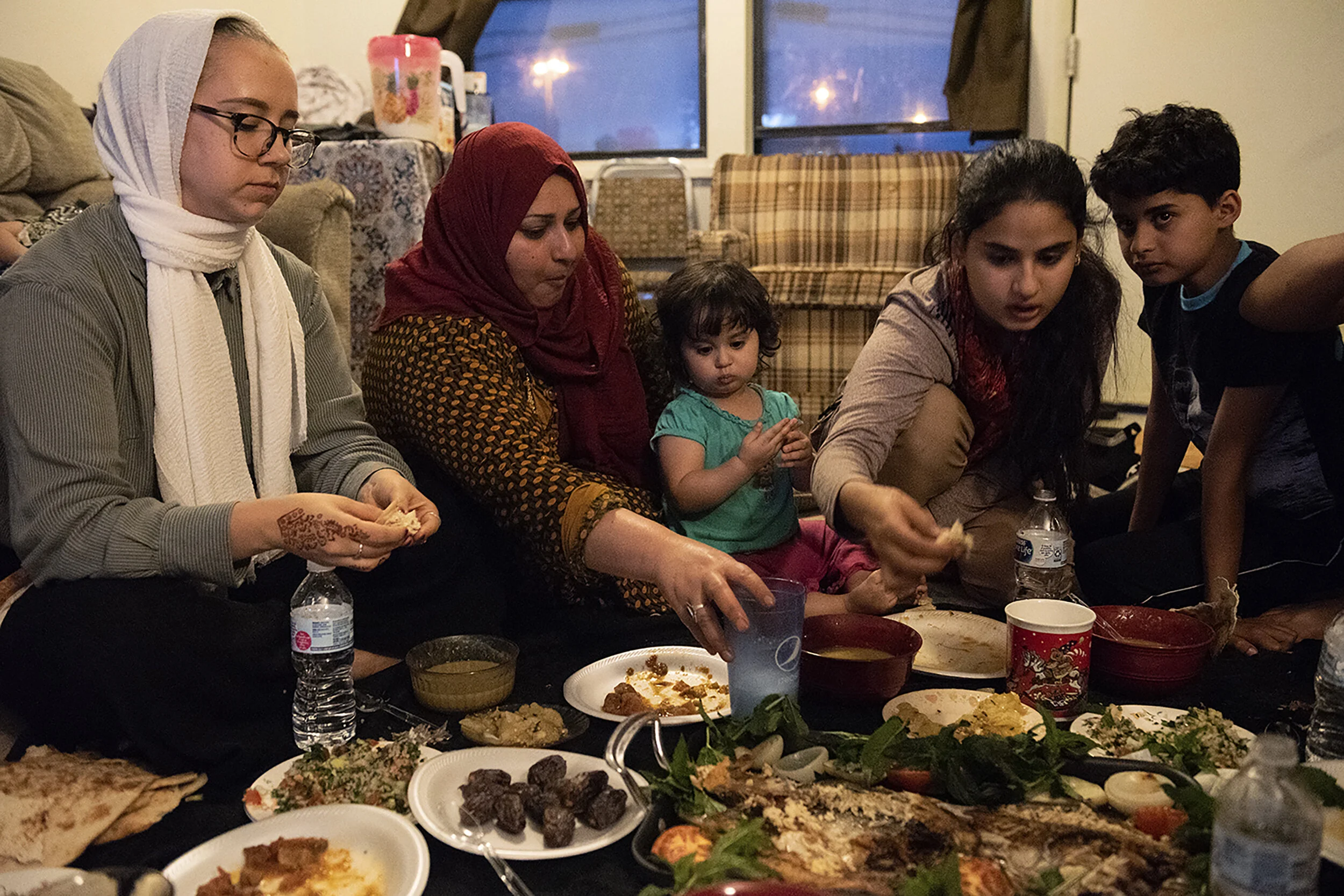  The Al Hraishawi family and Toni, a family friend and translator, break fast on the last day of Ramadan on Monday, June 3, 2019, at the family’s home in Columbia, Mo. It was one of the last nights that their father was there before he left again to 