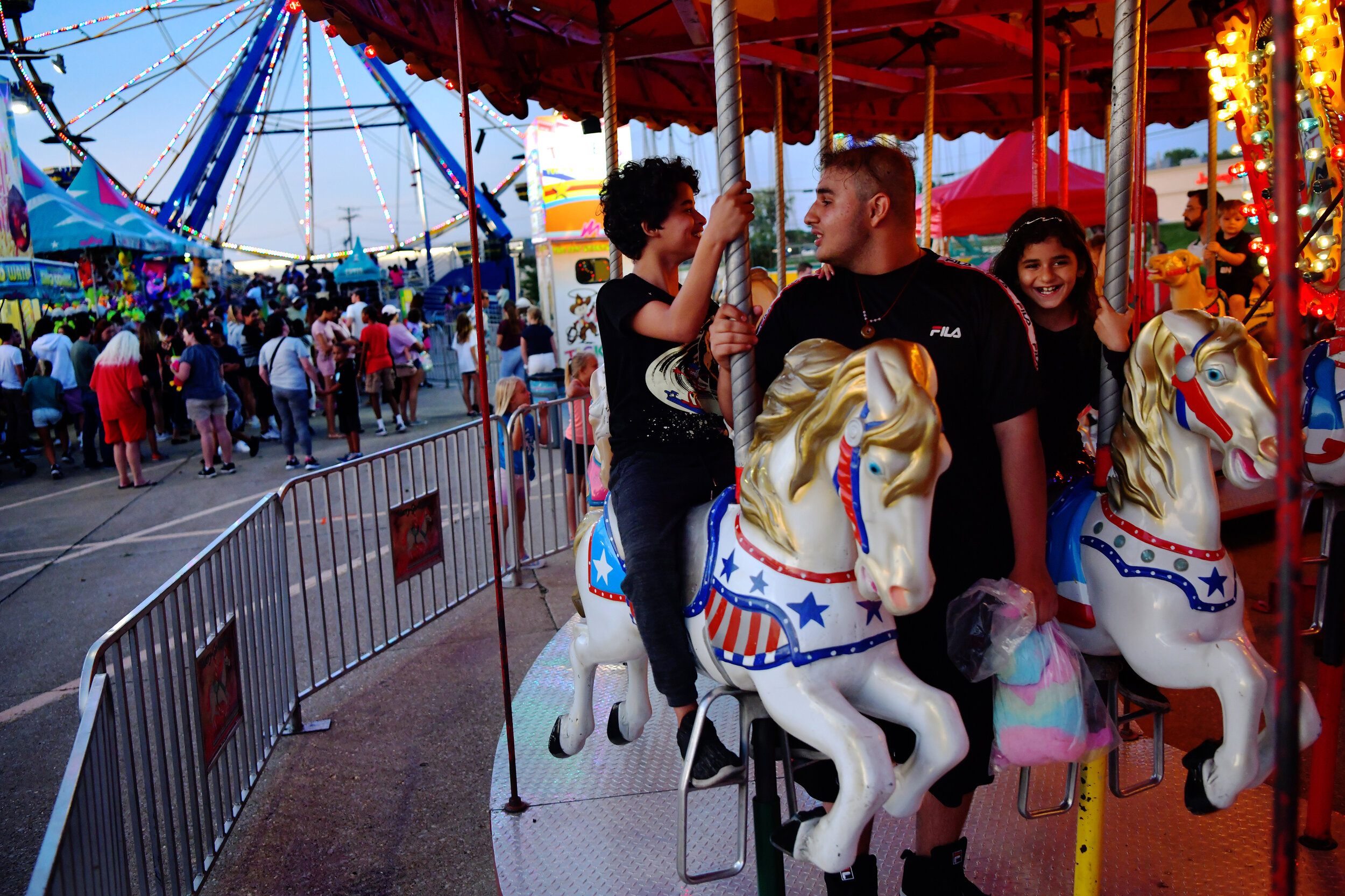  Al Hasan, Abbas, and Fatima ride the carousel at the Wade Show Carnival on Friday, August 23, 2019, at the Columbia Mall in Columbia, Mo. It was the siblings’ first time going to a carnival in the US. 