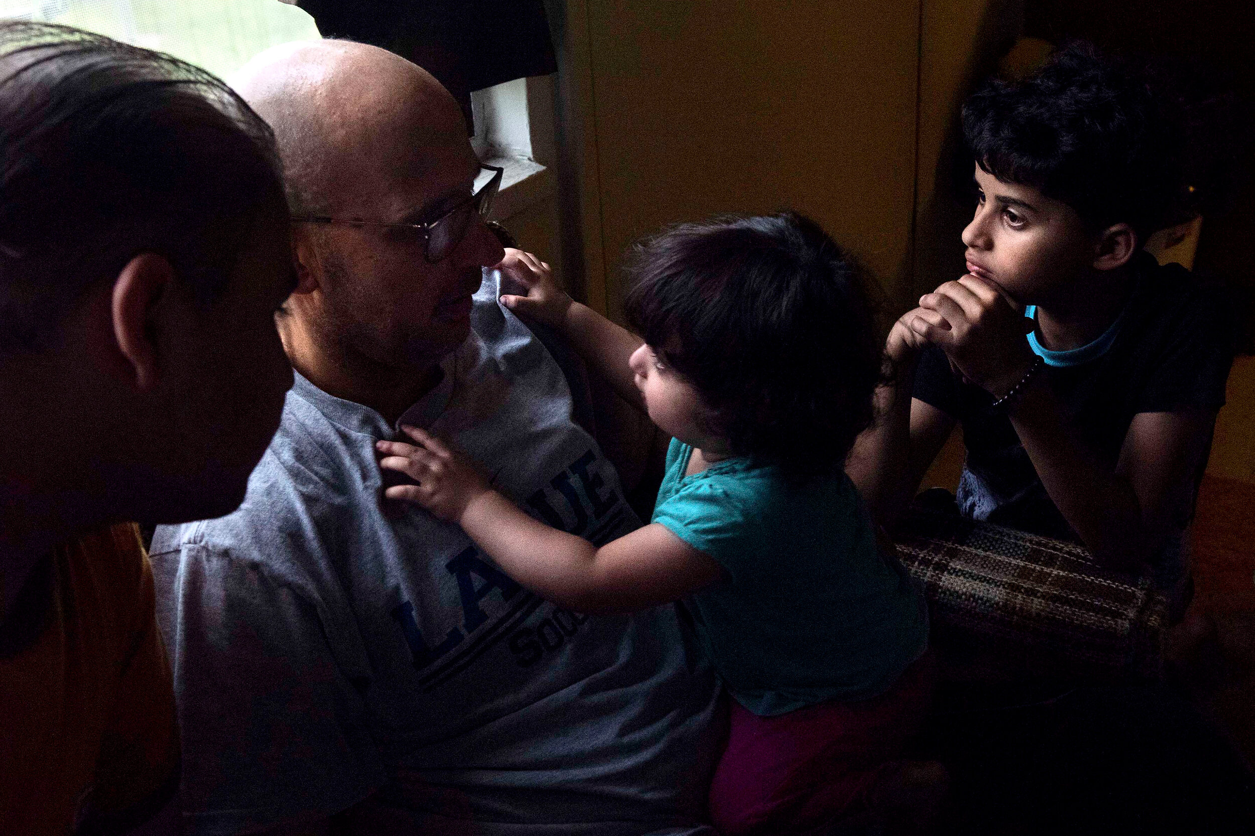  Zahra, 1, the youngest of the family, grabs onto her father Mohammed Al Hraishawi on the last day of Ramadan, on Tuesday, June 3, 2019, at their home in Columbia, Missouri. Their father plans to return to Iraq in a few days in order to continue his 