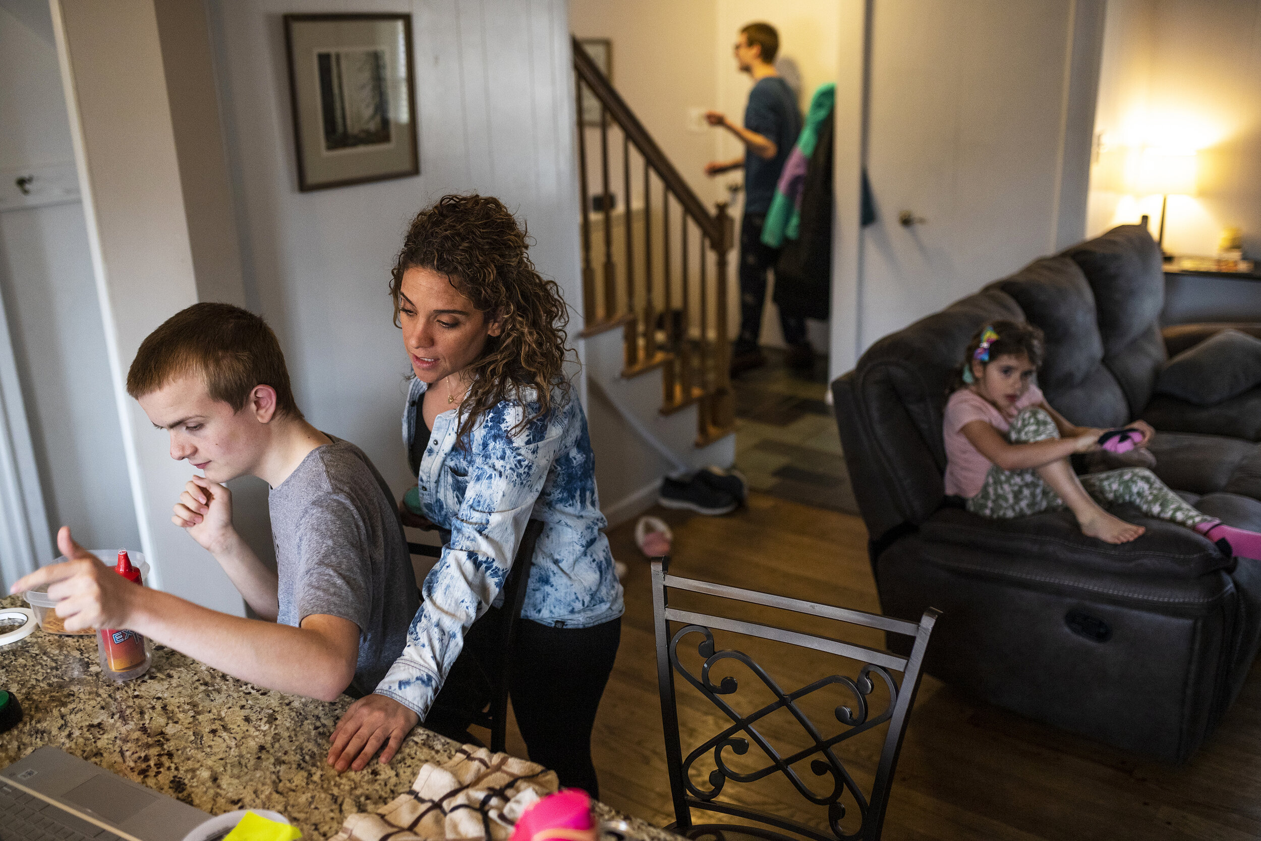  Danielle Vernon-Carleton watches her step-son Jackson, 16, do a virtual physical therapy class as her daughter Bella, right, gets ready to go outside and her step-son Andrew, top, paces around on Wednesday, March 10, 2021, in Troy. Danielle had to r