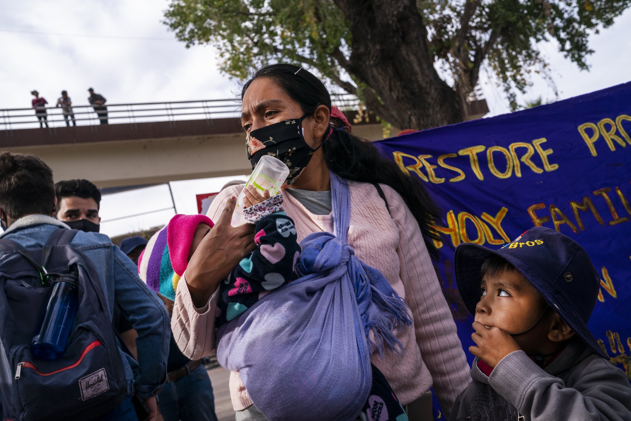  Cassandra Gonzalez holds onto her daughter Victoria, 1, and son Adalid, 4, while protesting for the rights of asylum seekers near the U.S. Customs and Border Protection - Dennis DeConcini Port of Entry on Nov. 8, 2021, in Nogales, Mexico. Gonzalez c