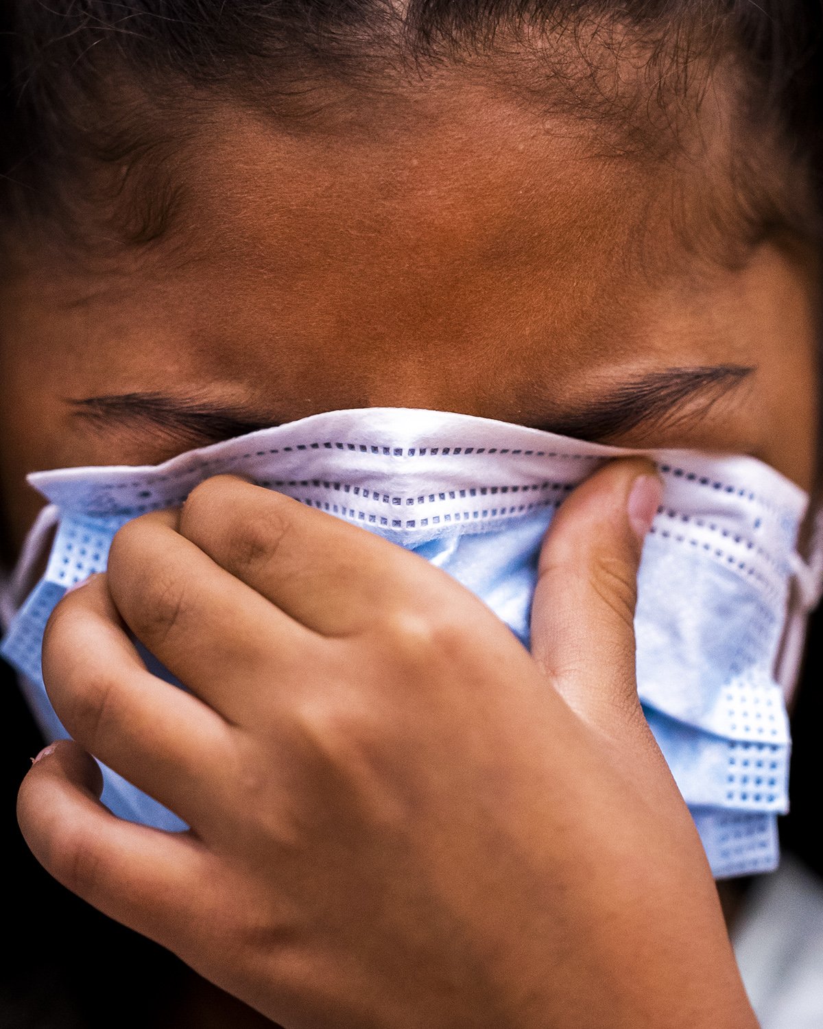  Rebeca Escalante, 8, of Mexico, puts her mask over her eyes as she's administered the COVID-19 vaccine on Saturday, Nov. 6, 2021, at Carl Hayden Community High School in Phoenix. Escalante recently immigrated to the United States through Texas with 