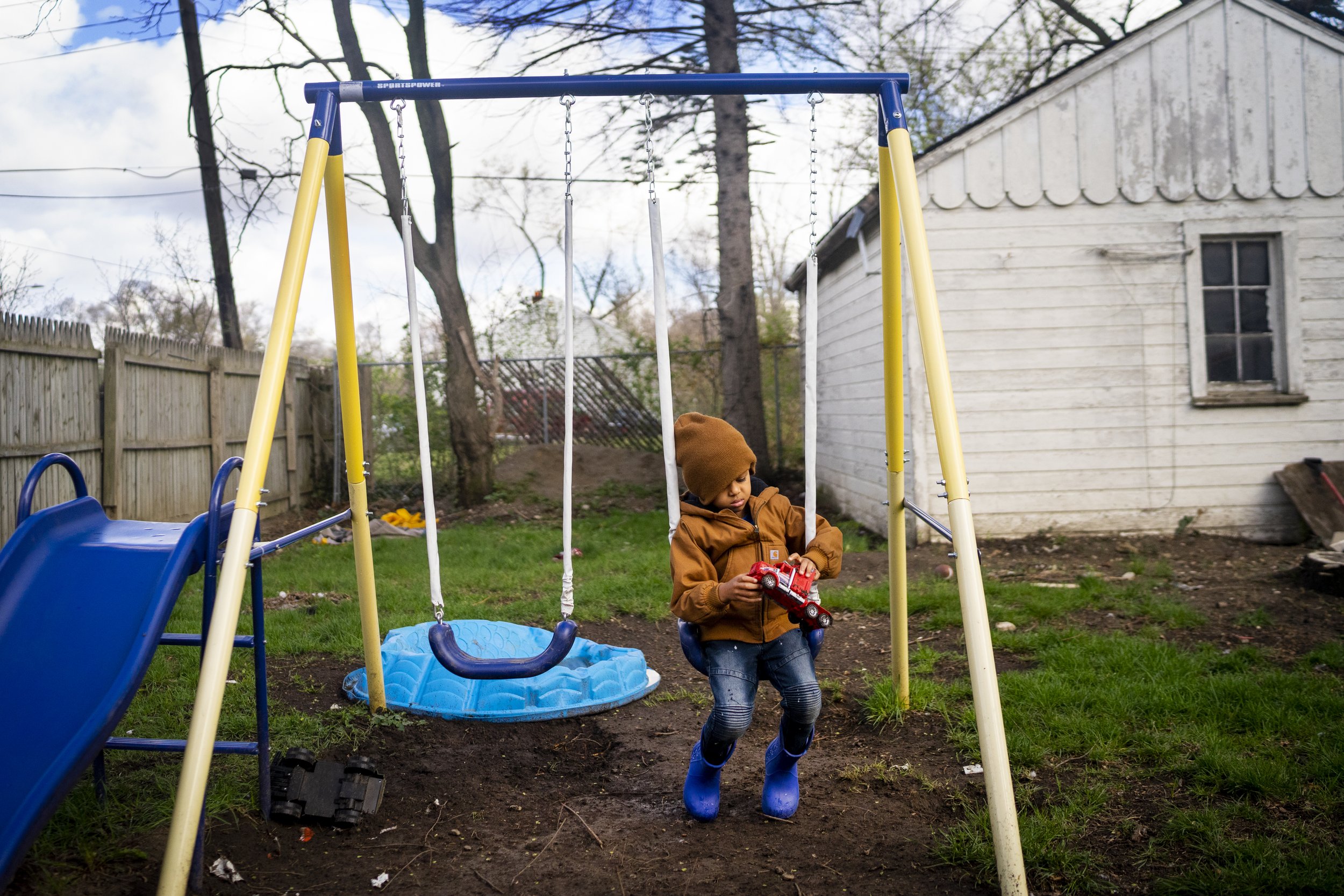  MyKail Moultrie, 4, plays with a toy truck on his backyard swing on Sunday, April 11, 2021, in Detroit. Since a young age, MyKail was non-verbal which led his parents to get him tested for autism. MyKail's mother,Tiera Lavin, now runs a business cal