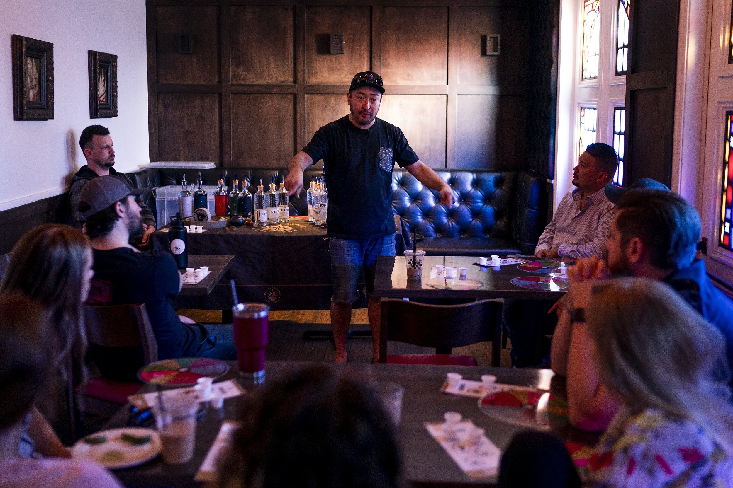  Iván Carreño, center, co-founder of Compa Spirits, teaches a mezcal class for bar staff at Taco Guild in Phoenix on Thursday, Dec. 2, 2021. Carreño put a second mortgage on his mother's home to help start his company a year ago. He spends most his t