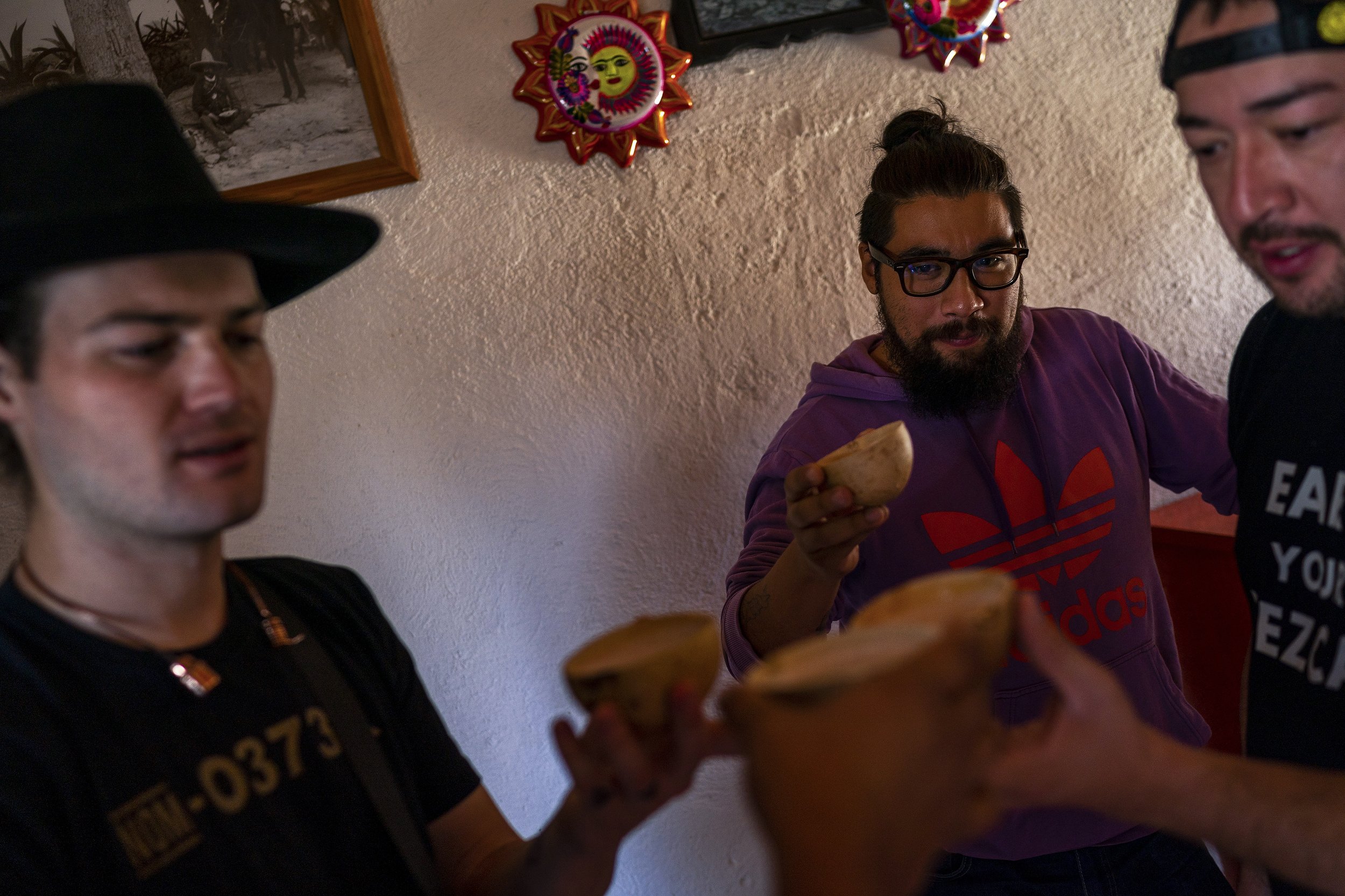  From left, Caleb West, Daniel Soria and Iván Carreño drink pulque at El Pulquito de Matatlán on Dec. 8, 2021, in Santiago Matatlán, Oaxaca, Mexico. Pulque is juice of the agave heart which was originally consumed before the process of distillation w