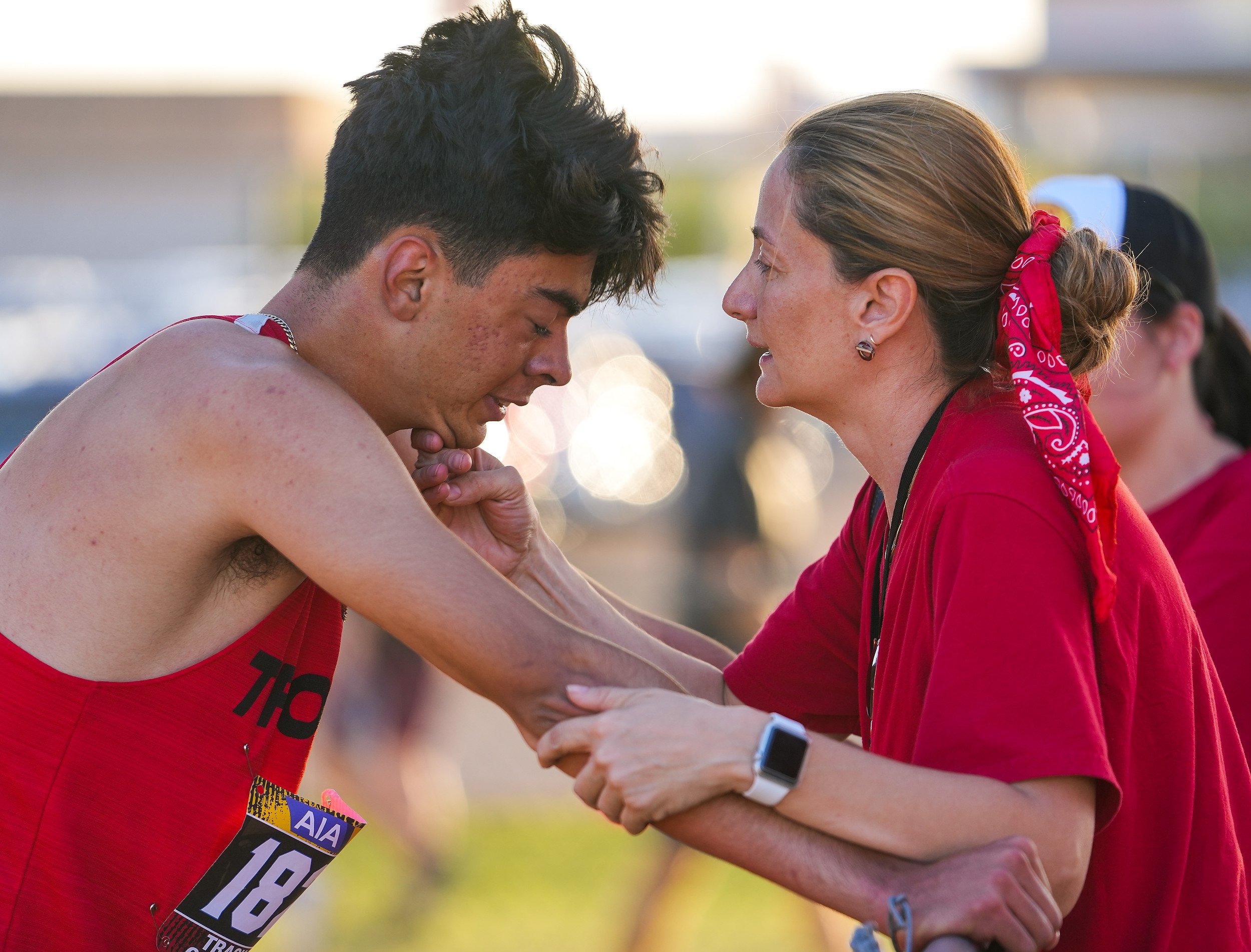  Paradise Valley's Erick Reyes is comforted by his mother Regina Reyes, right, after falling at the last hurdle during the Boys 300 Meter Hurdles Division Two race during the AIA State Track & Field Championships 2022 at Mesa Community College on Sat
