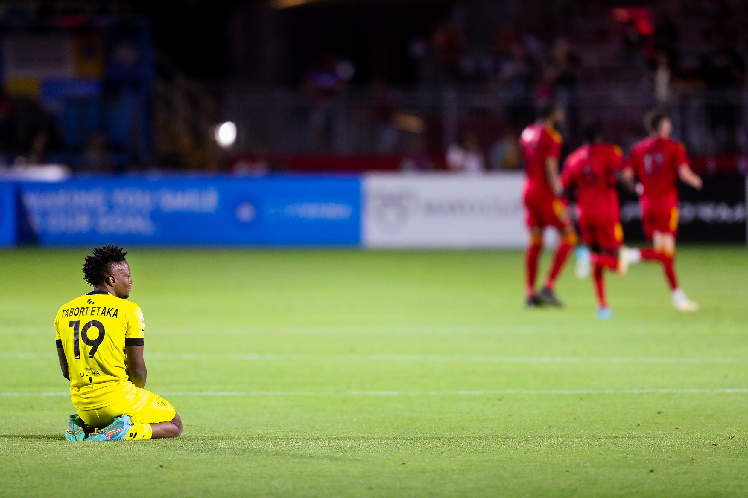  United forward Preston Etaka (19), left, sits disappointed after losing the match against Phoenix Rising FC on Saturday, April 16, 2022, in Chandler. Rising beat the United 1-0 after a fist half goal and a late penalty kick stop by Phoenix Rising FC