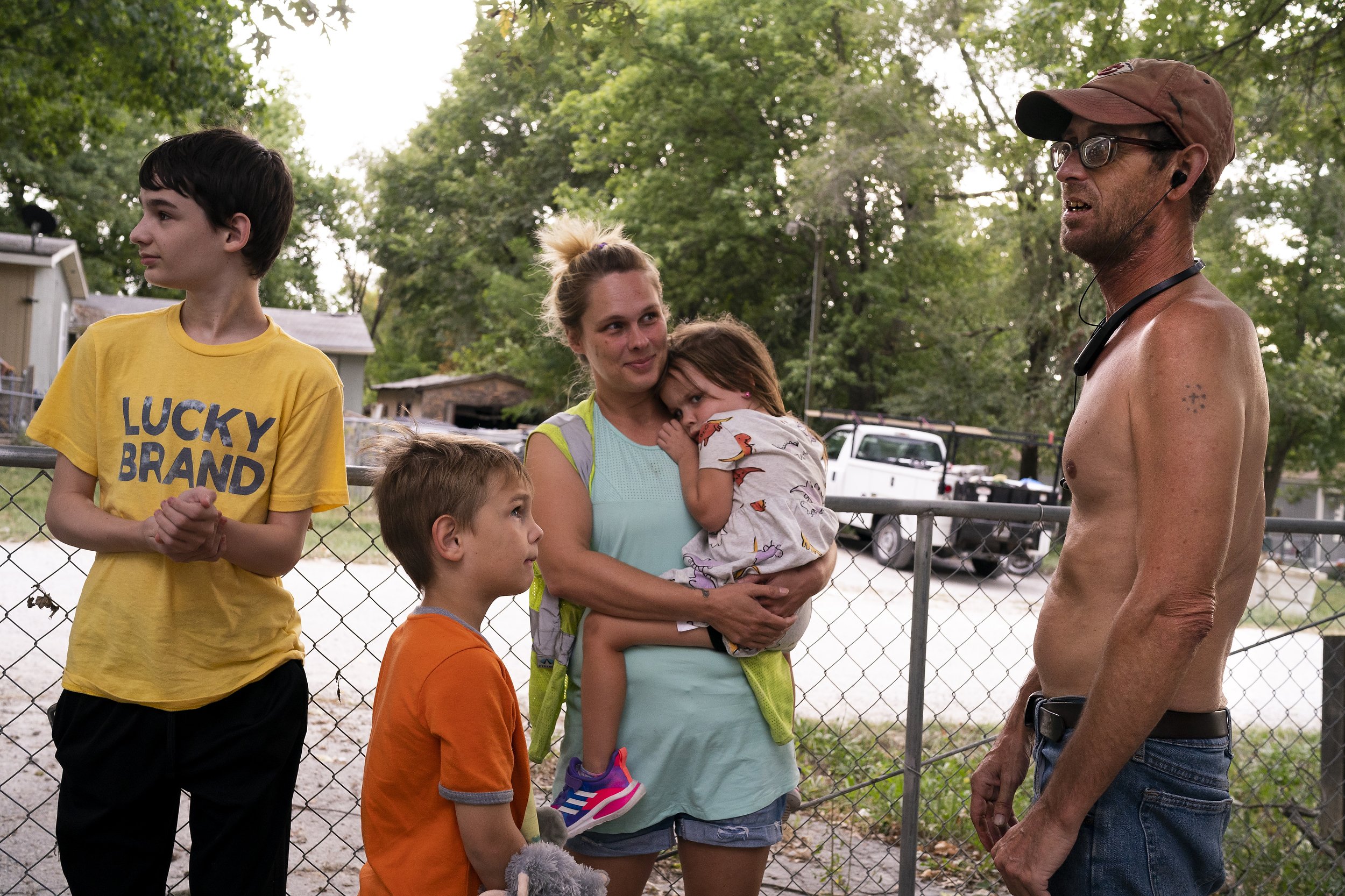  Elizabeth Singleton, center, smiles at her uncle Daryel Franklin Miller, right, during a visit to her grandfather Daryel Miller's house after work with her children Cameron, 12, left, Landon, 7, center left, and Nora, 4, center, on Wednesday, Septem