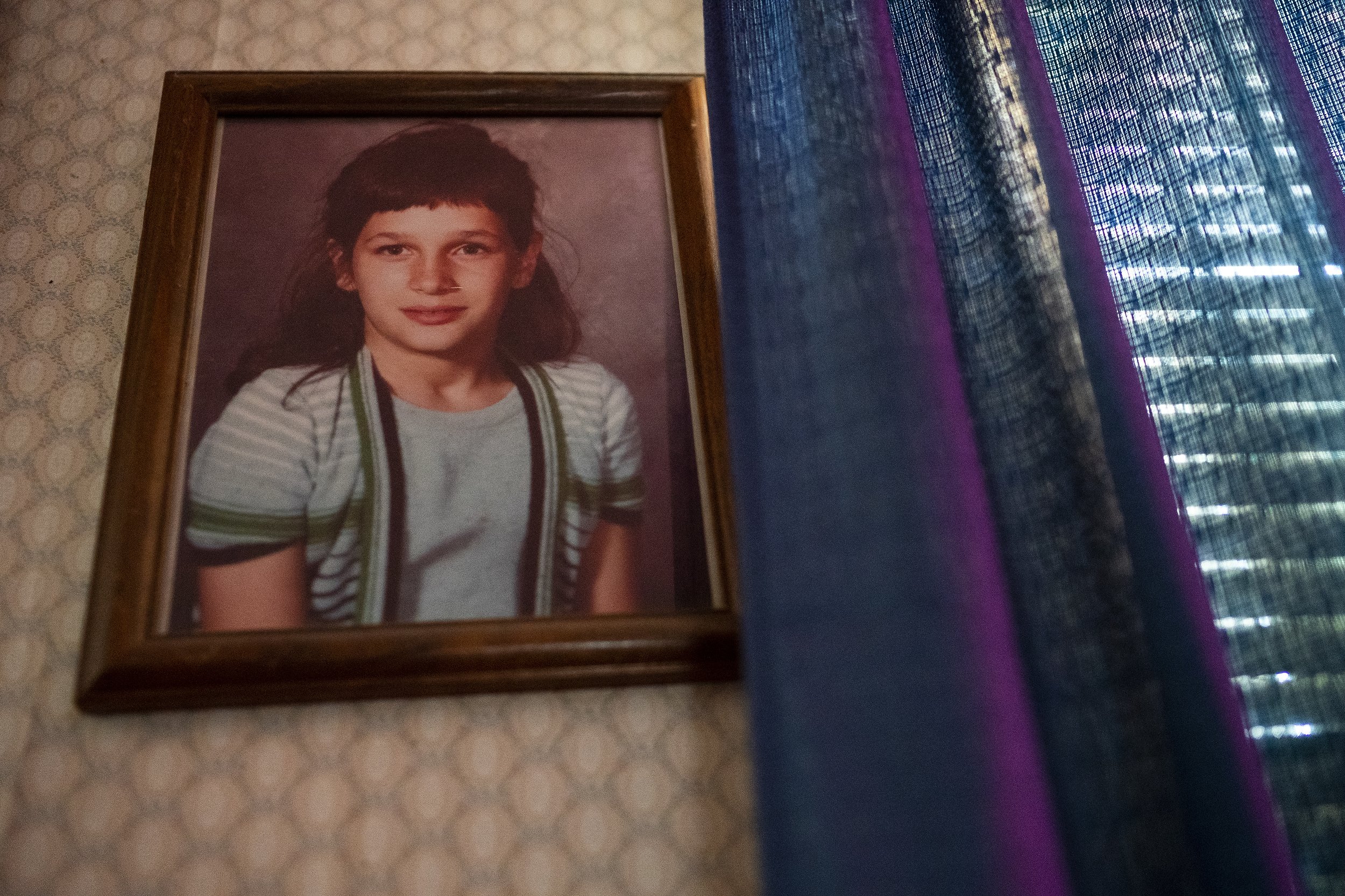  A portrait of Donna Jean Miller, Daryel's deceased older sister, hangs in his father's home. Donna Jean passed at the age of 12 while saving Daryel from drowning in a pool he'd snuck into.  