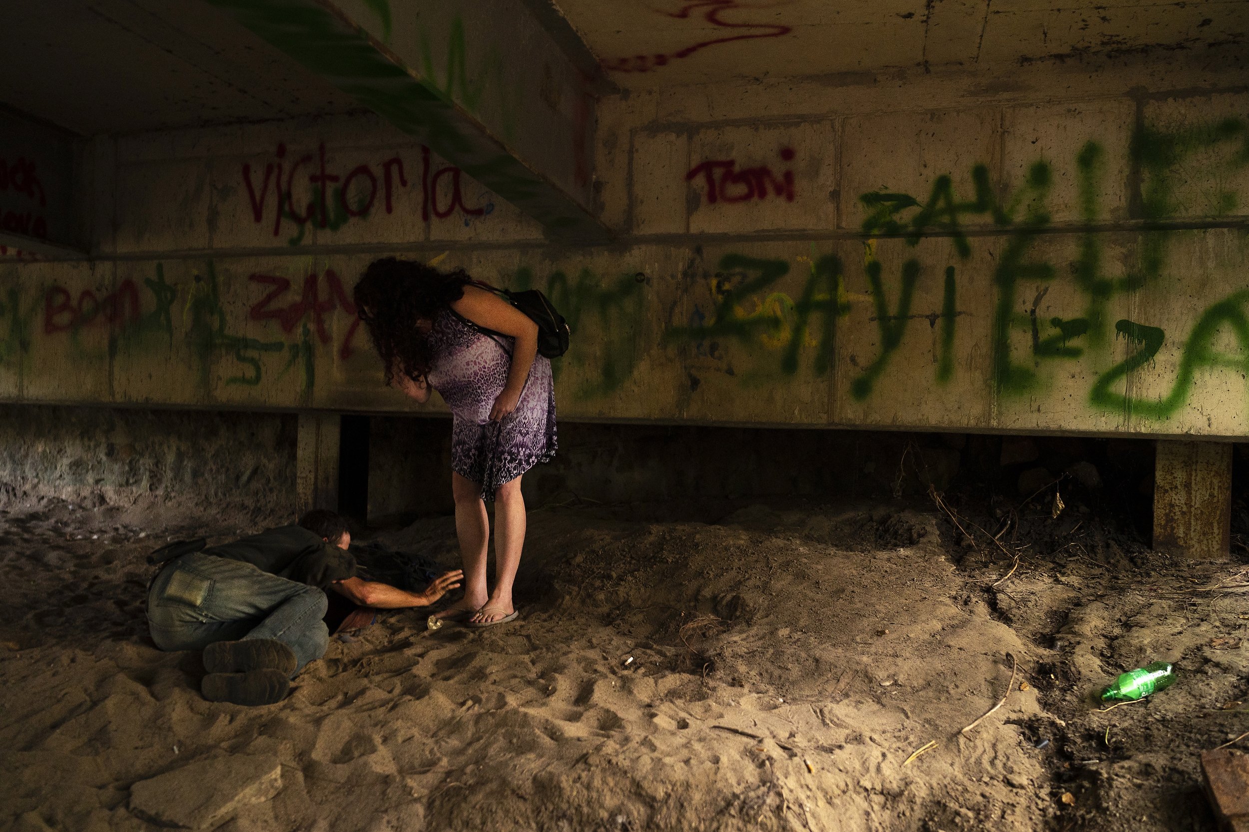  Daryel Franklin Miller, 50, at left, reaches out to his lifelong friend Lori Lafferty, 51, as she wakes him up after he spent the night sleeping under a bridge on Thompson Avenue in downtown Excelsior Springs on Sunday, September 18, 2022, in Excels