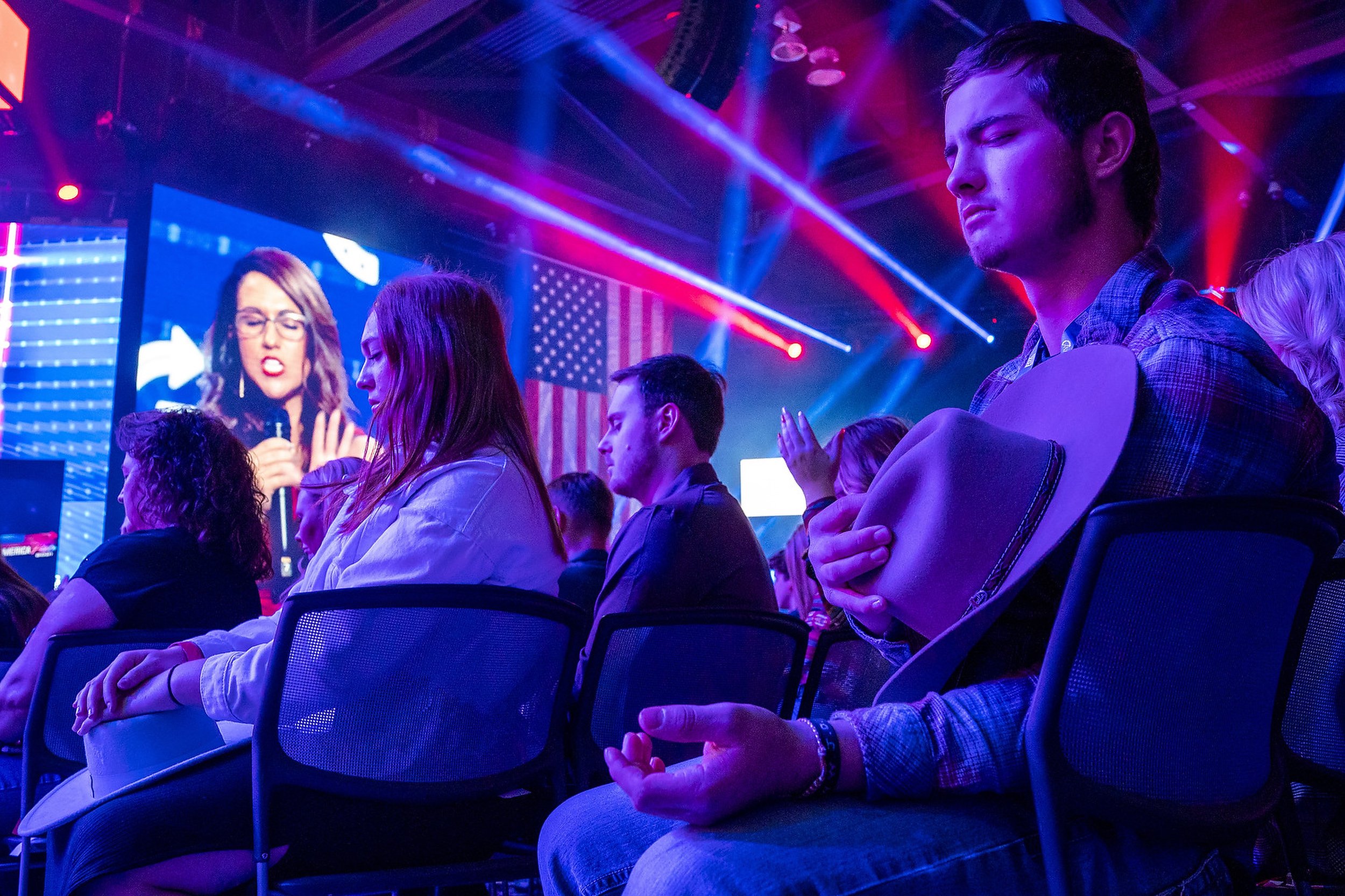  Attendees pray as Rep. Lauren Boebert (R-CO) leads a prayer during the third day of AmericaFest 2021 hosted by Turning Point USA on Sunday, Dec. 19, 2021, in Phoenix. The four day convention advertises itself as a event to mobilize young conservativ