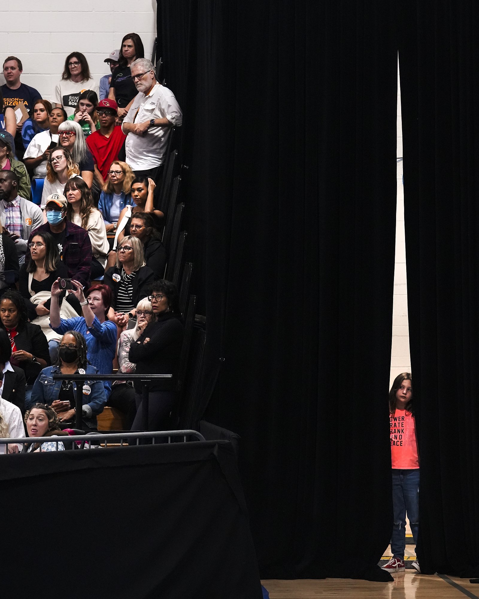  Hattie Mayes, at right, watches as her mother Kris Mayes, candidate for Arizona attorney general, speaks during a rally at Cesar Chavez High School on Wednesday, Nov. 2, 2022, in Phoenix. Former President Barack Obama highlighted the rally which was