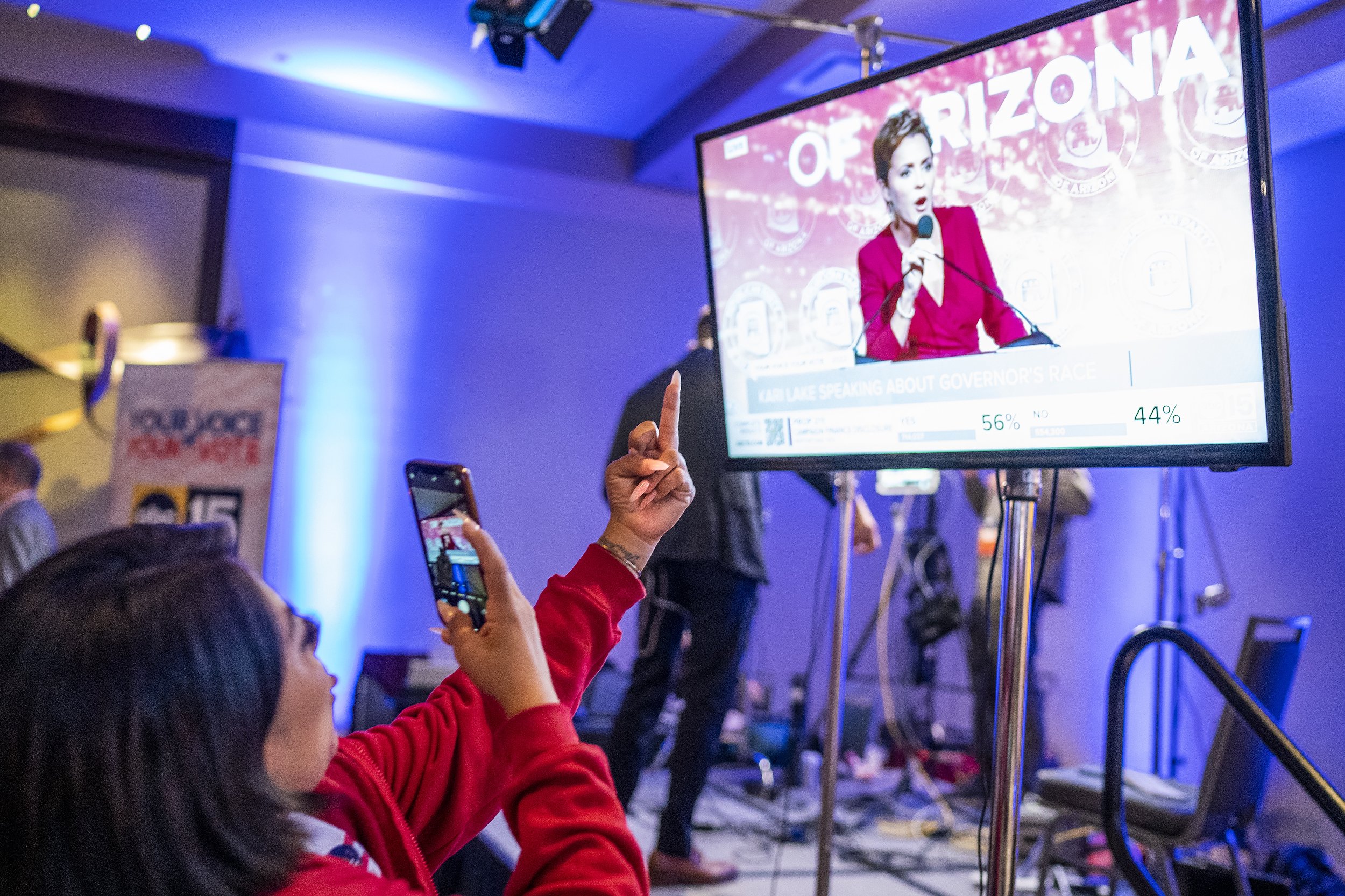  Tiffany Del Rio takes a video of herself giving the finger to Kari Lake on a television at the democratic candidates Election Night watch party at the Renaissance Phoenix Downtown Hotel as Lake gives a speech to attendees at the Republican Election 