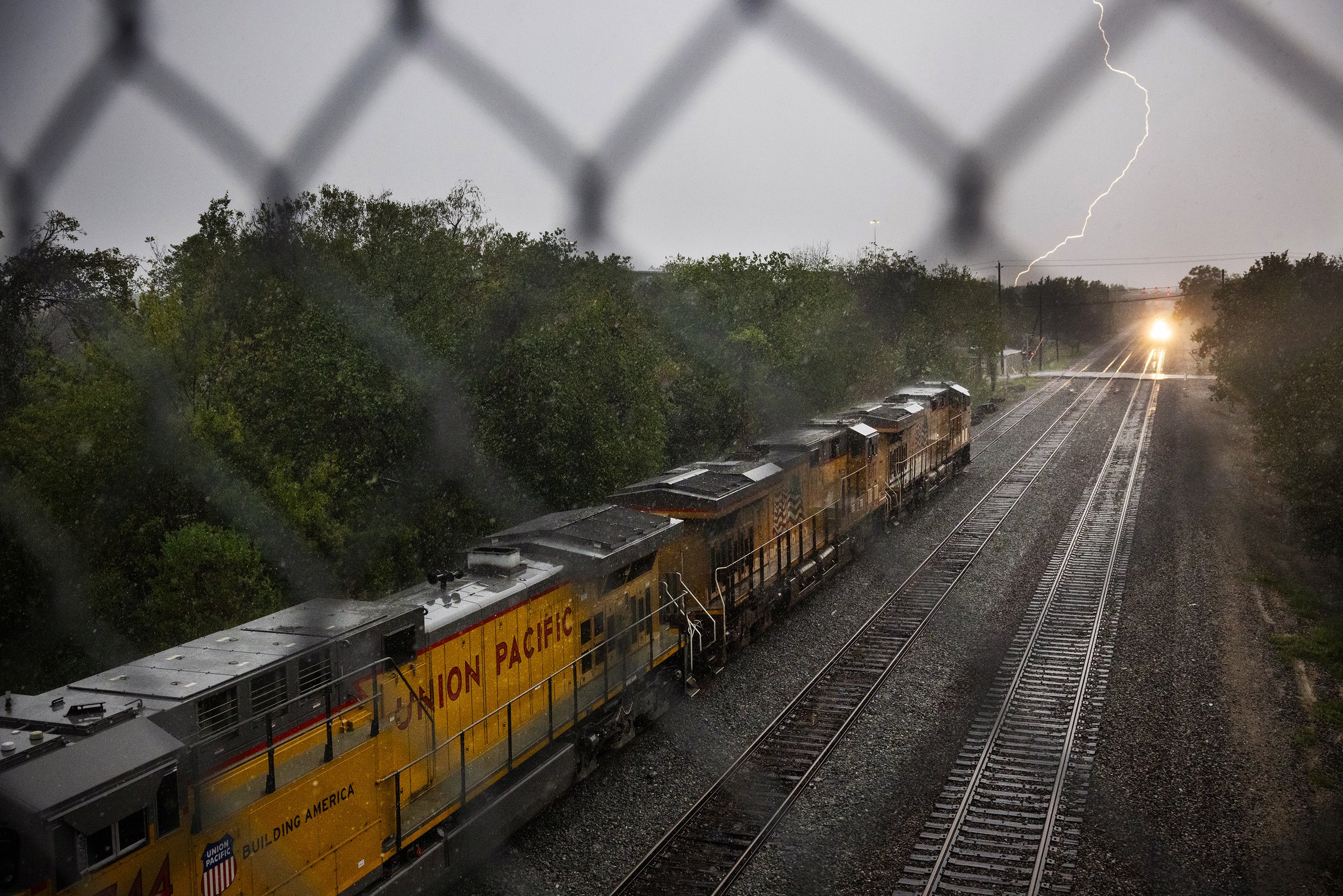  Lighting strikes as a Union Pacific train is parked near Worms street, Monday, Sept. 25, 2023, in Houston. With each major weather event Houston experiences, the toxic plume caused by years of Union Pacific dumping the wood presented creosote moves 