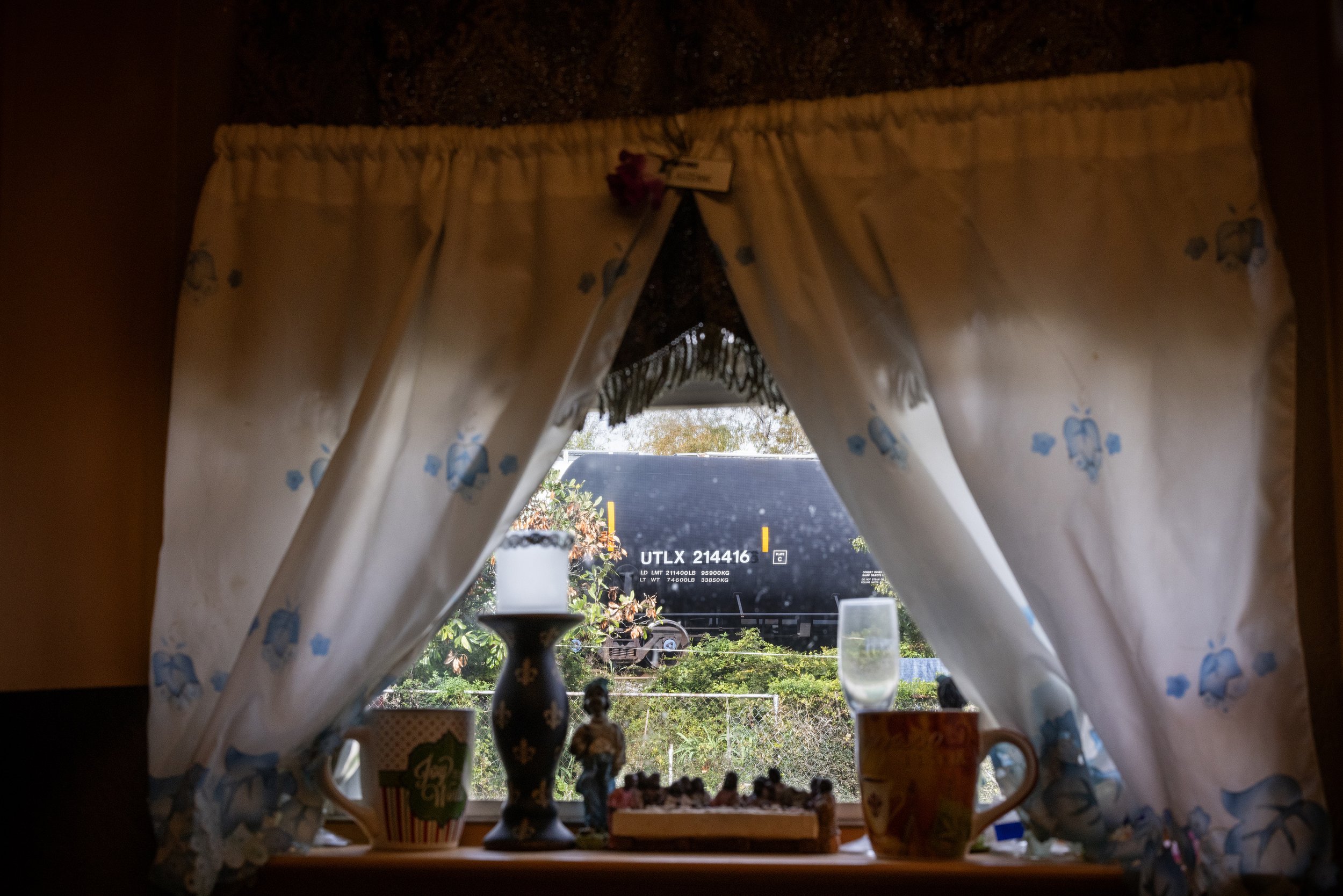  A Union Pacific train is seen parked on the tracks through Sandra Auzenne’s kitchen window, Wednesday, Nov. 29, 2023, in Houston. With no city assistance for relocation, Auzenne is planning on using whatever she makes from the sale of her house – wh