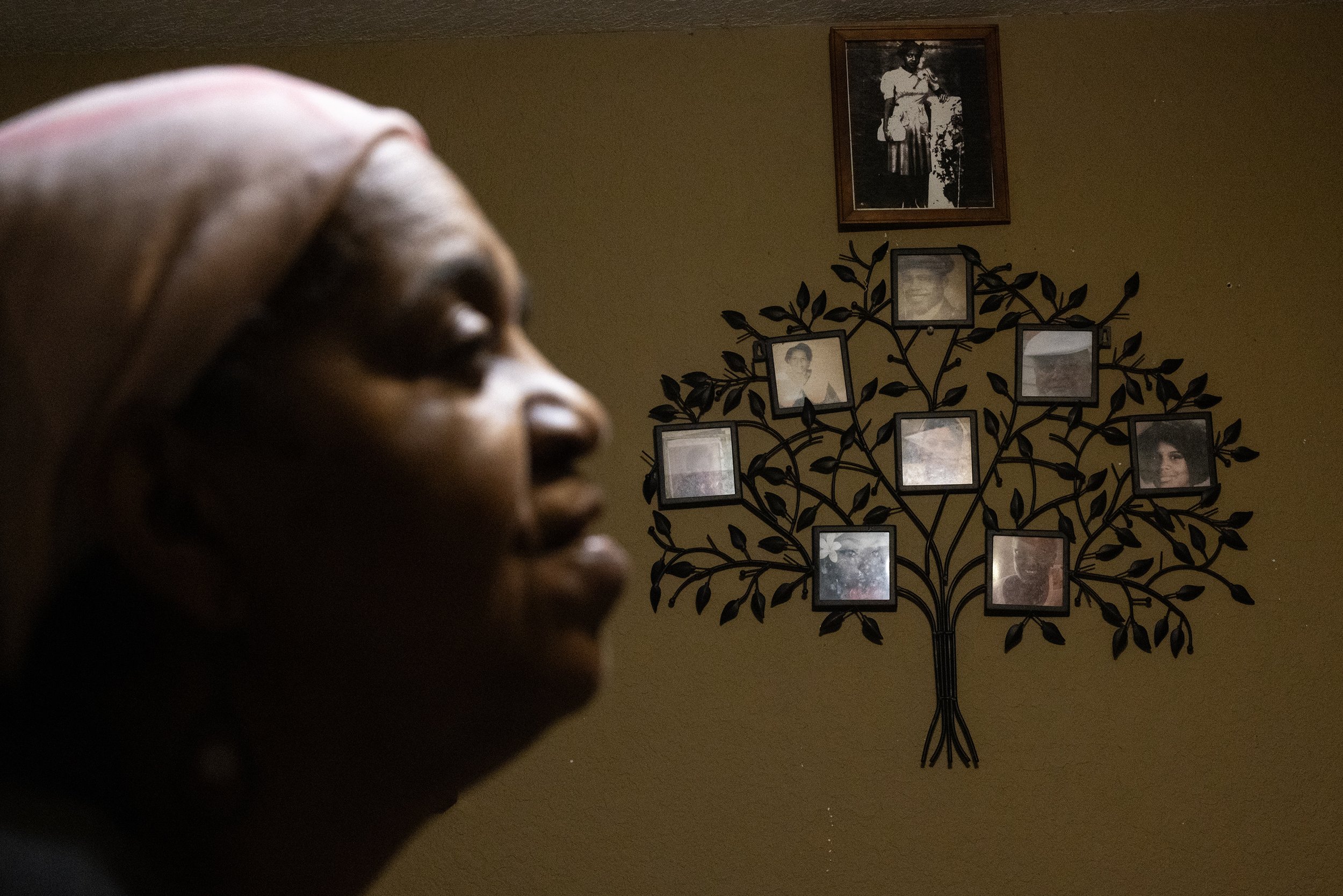  Sandra Auzenne speaks about the family loss she’s experienced over the years as a family tree is seen hanging on the wall of her living room, Thursday, Nov. 9, 2023, in Houston.  